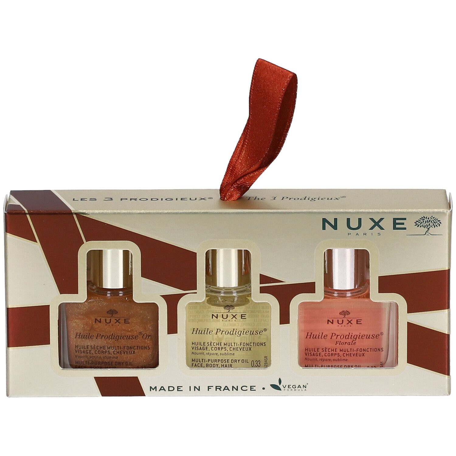Coffret cadeau avec trois flacons d'huile. Logo Nuxe, nom du produit, label vegan. Ruban rouge pour suspendre.