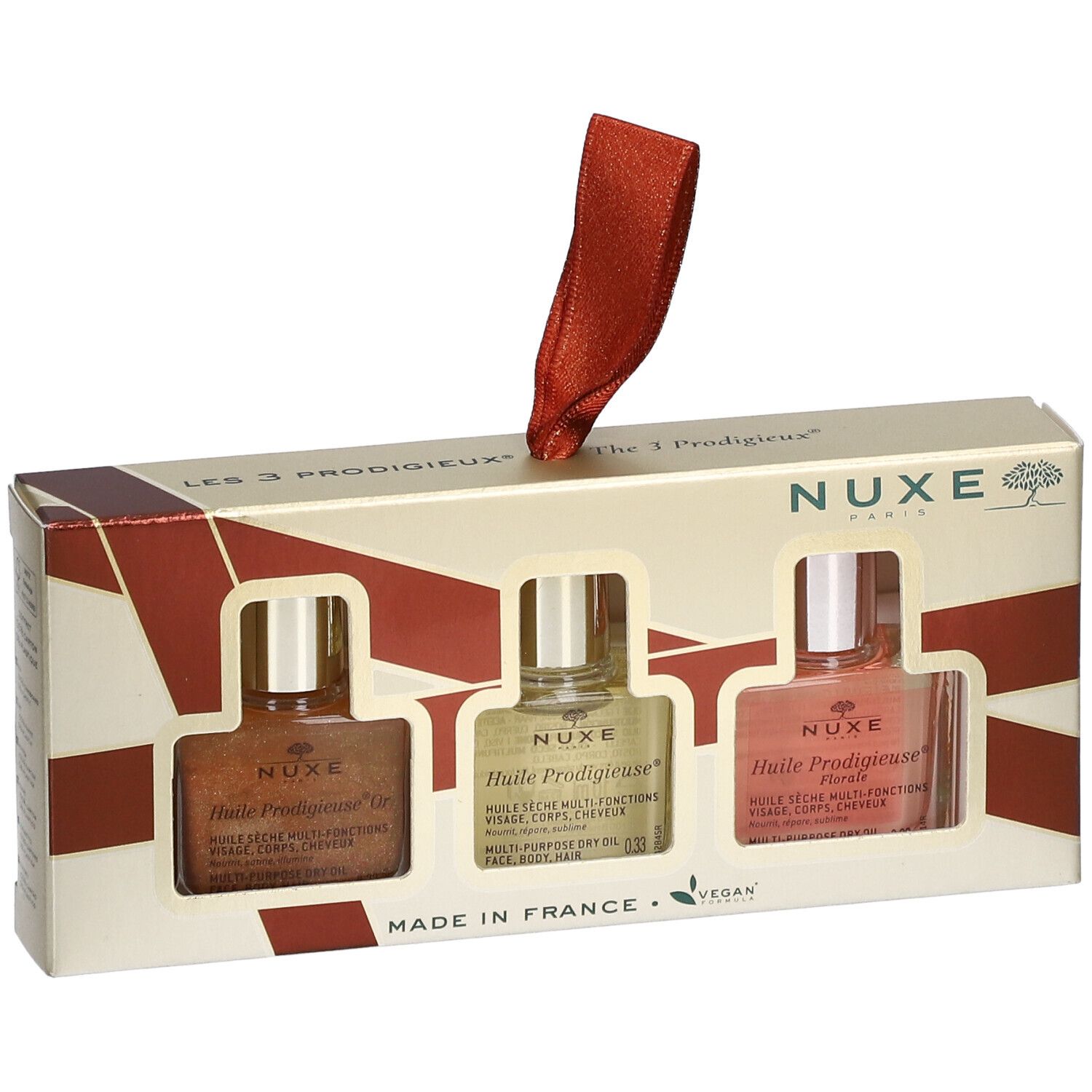 Coffret cadeau avec trois flacons d'huile. Logo Nuxe, nom du produit, label vegan. Ruban rouge pour suspendre.