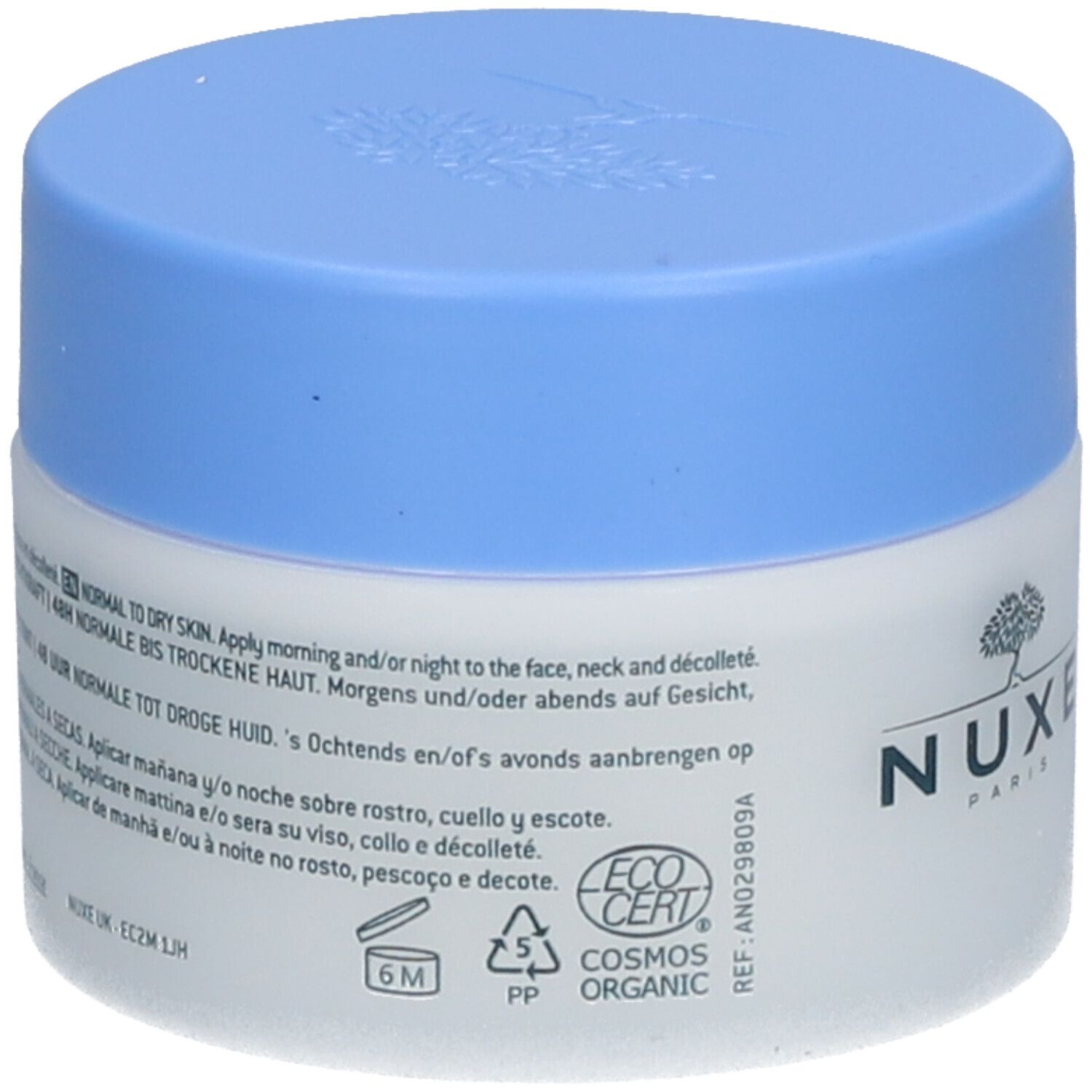 Pot de crème avec couvercle bleu. Inscription : NUXE Paris. Texte : Pour peaux normales à sèches. ECOCERT COSMOS ORGANIC.