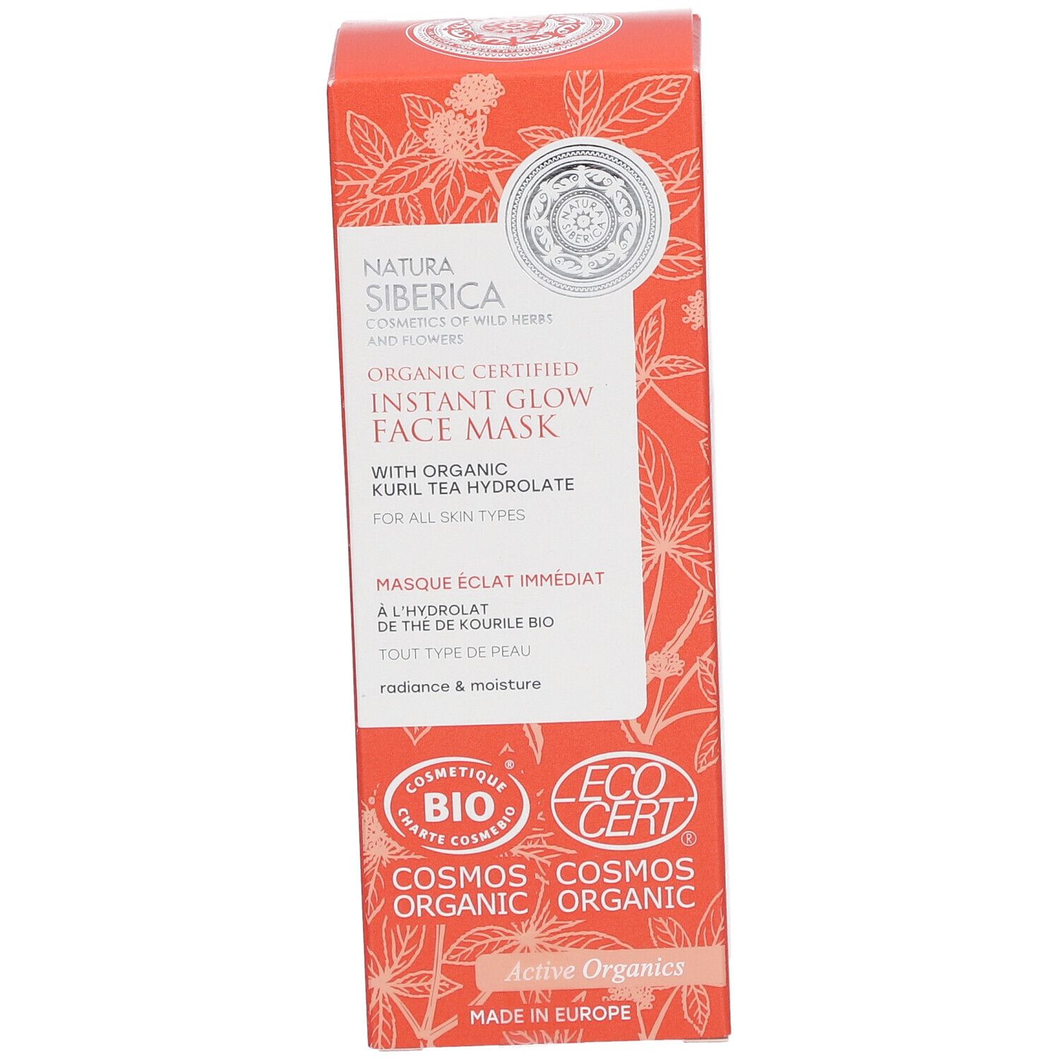 Emballage de masque facial. Boîte orange avec motifs floraux et informations produit. Logos : COSMOS ORGANIC, ECOCERT.