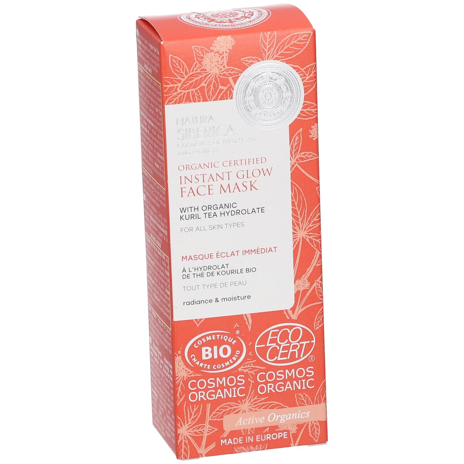 Emballage de masque facial. Boîte orange avec motifs floraux et informations produit. Logos : COSMOS ORGANIC, ECOCERT.