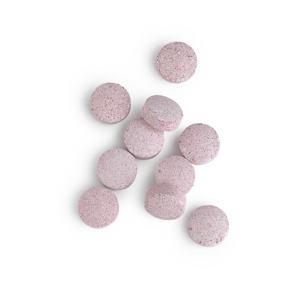 10 comprimés ronds roses. Sur fond blanc.