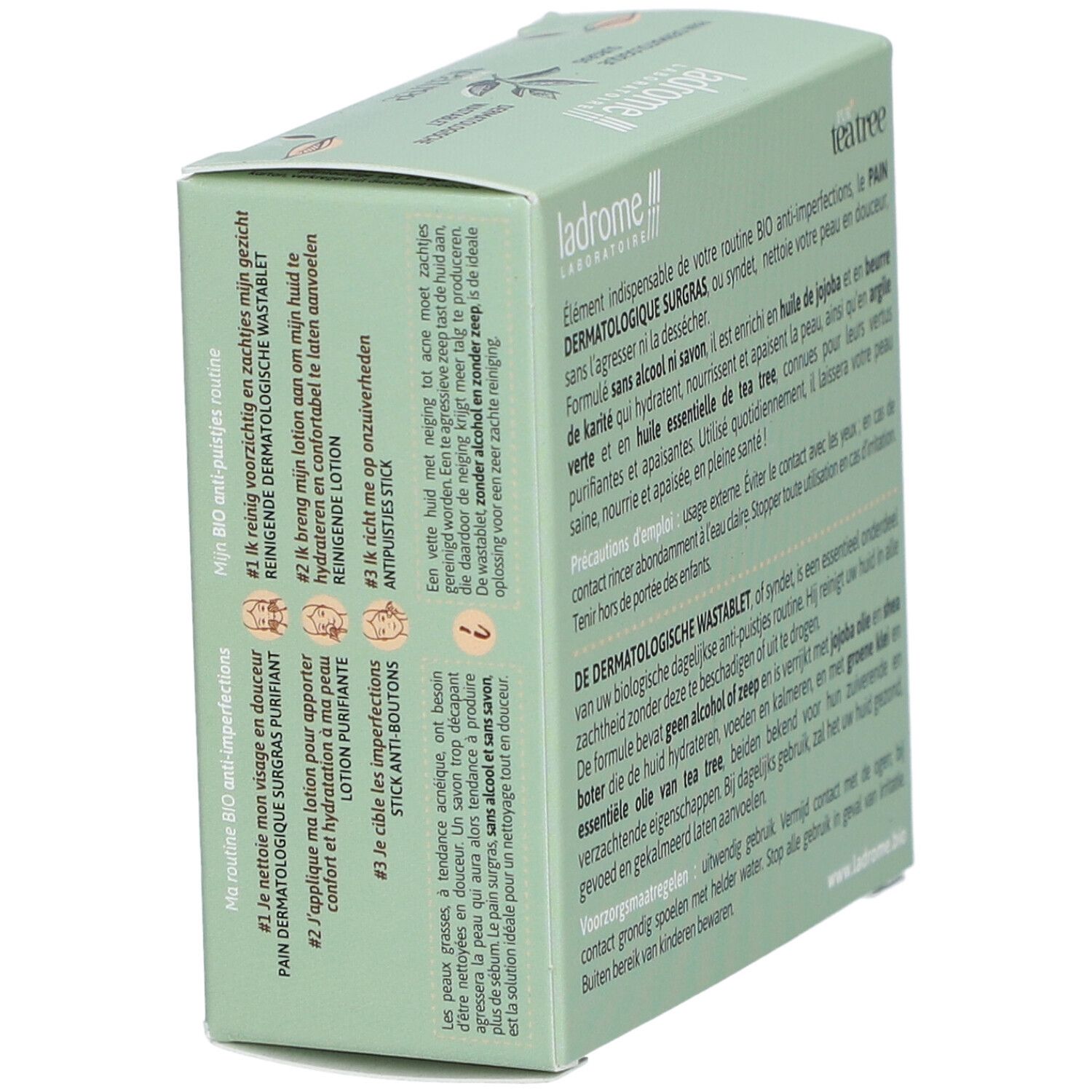 Boîte avec informations sur le produit. Texte : Pur Tea Tree, Pain Dermatologique surgras, Dermatologische wastablet. Stick anti-boutons.