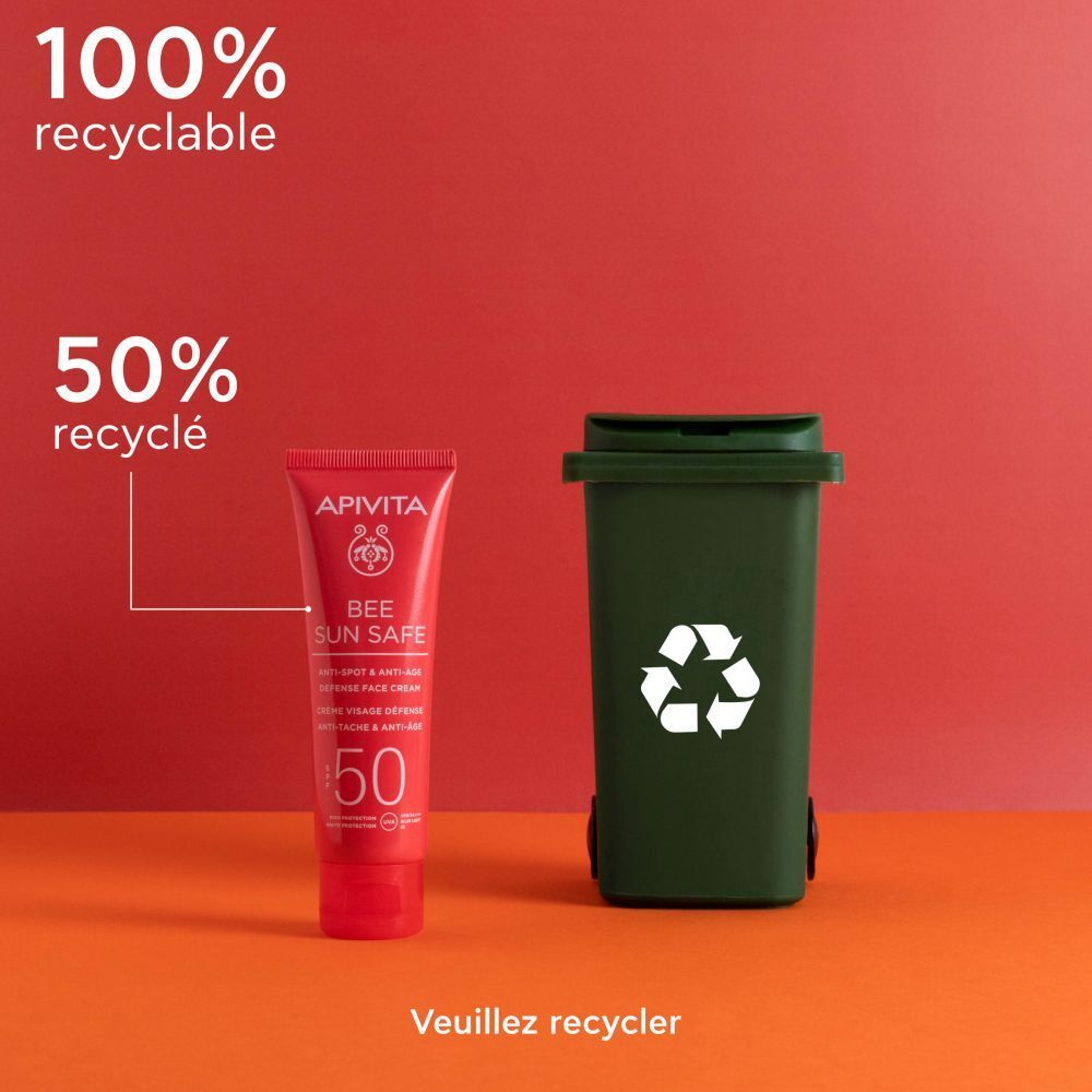 Produit et poubelle. Tube rouge: Apivita Bee Sun Safe. 100% recyclable.