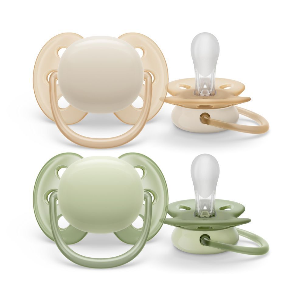 Quatre sucettes, deux ensembles. Chaque ensemble comprend une sucette à tétine ronde et une à tétine plate. Couleurs : beige et vert.