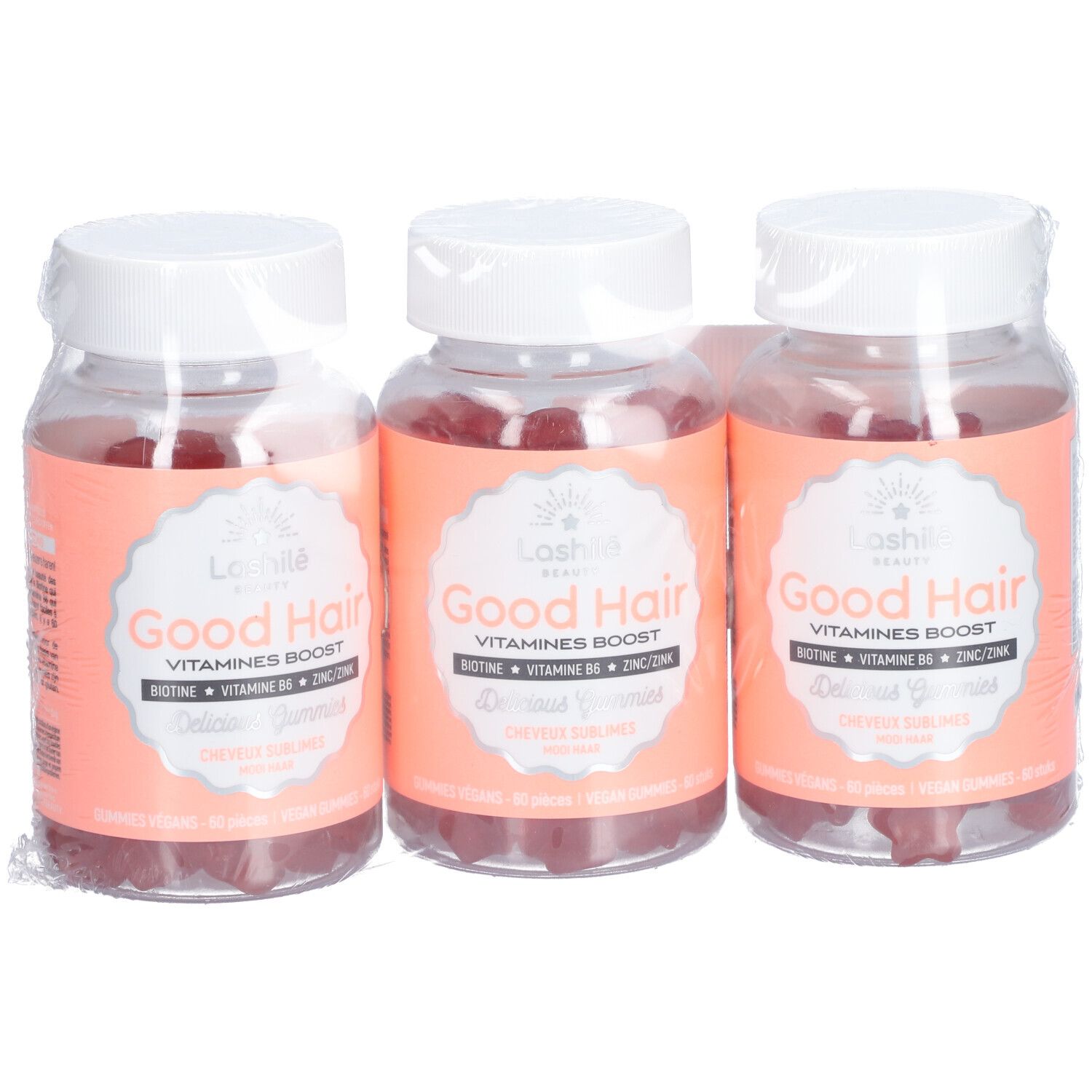 Trois flacons de gummies emballés. Inscription: Good Hair, Vitamines Boost. Étiquettes roses.