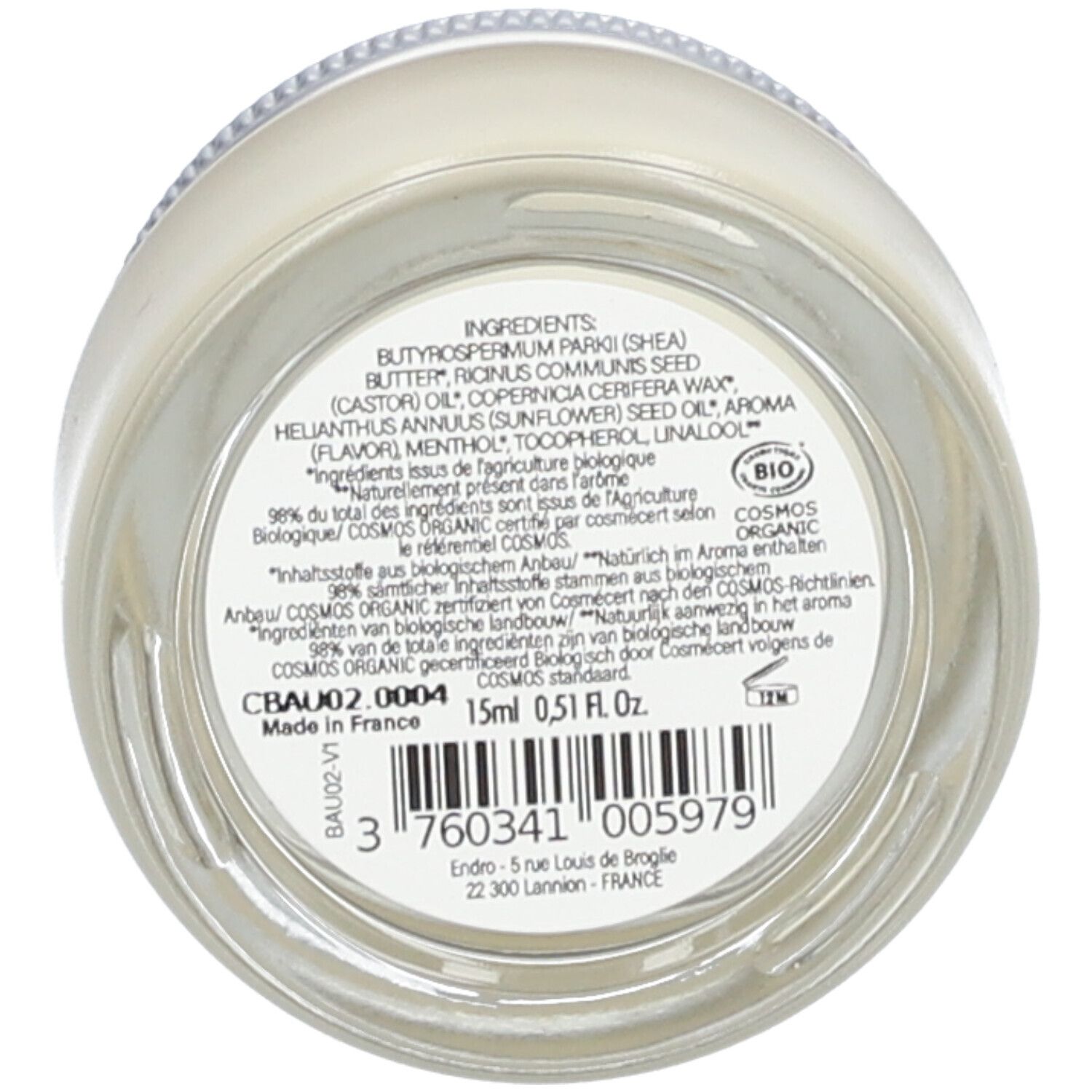 Fond en verre avec ingrédients et informations fabricant. Texte : "Ingredients", "COSMOS ORGANIC", code-barres, "15ml".