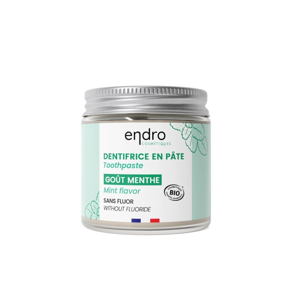 Tandpasta in een pot. Opschrift "endro", "DENTIFRICE EN PÂTE", "Gout Menthe", bio-certificering. Zilveren deksel.