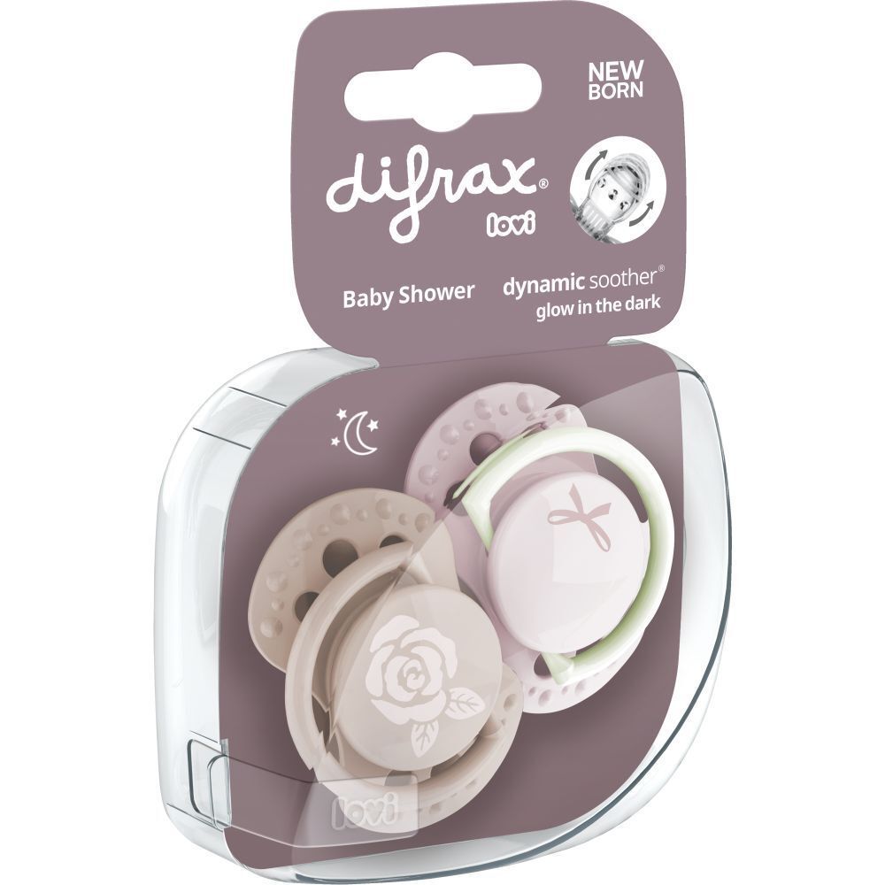 Emballage avec deux sucettes. Rose et beige. Marque : Difrax. Texte : Baby Shower, sucette dynamique, brille dans le noir.