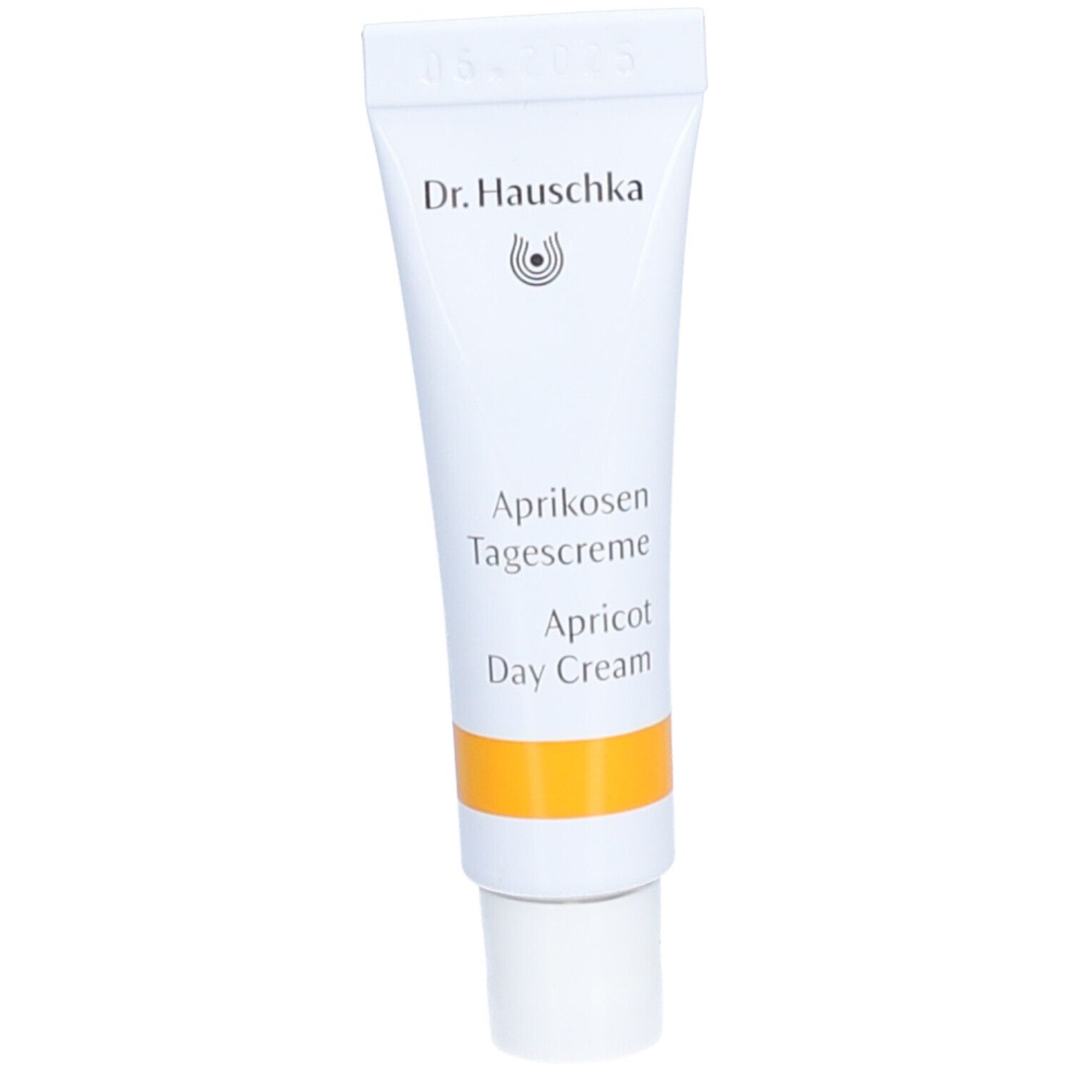 Weiße Tube mit gelbem Streifen. Aufschrift: Dr. Hauschka, Aprikosen Tagescreme, Apricot Day Cream.