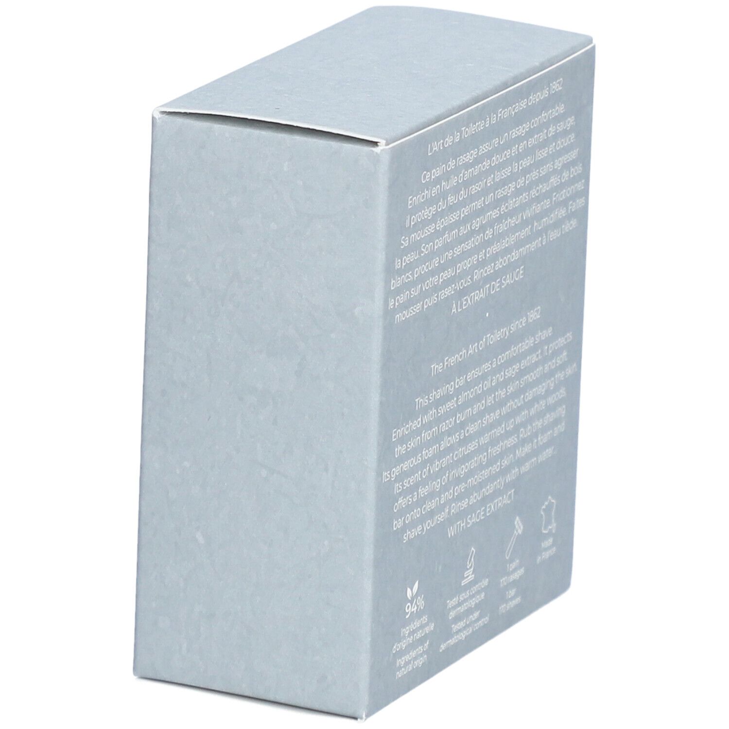 Boîte grise. Logo et texte. Texte: Cologne Twist, Pain de Rasage, 100 g, net wt. 3.5 oz. Texte au dos.