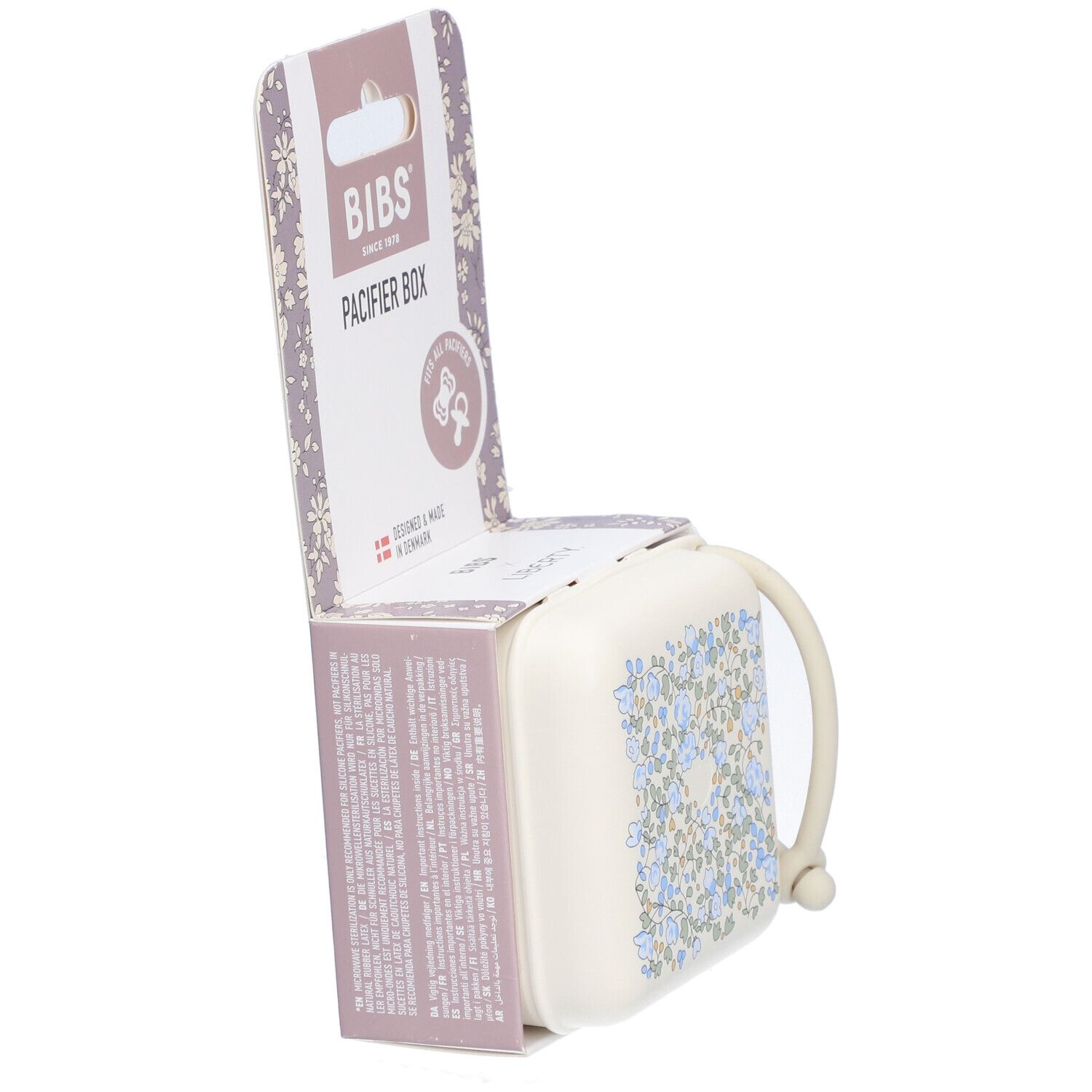 BIBS Schnullerbox in Verpackung. Beige Box mit blauem Blumenmuster. Box geöffnet, Griff sichtbar. Verpackung mit Logo.