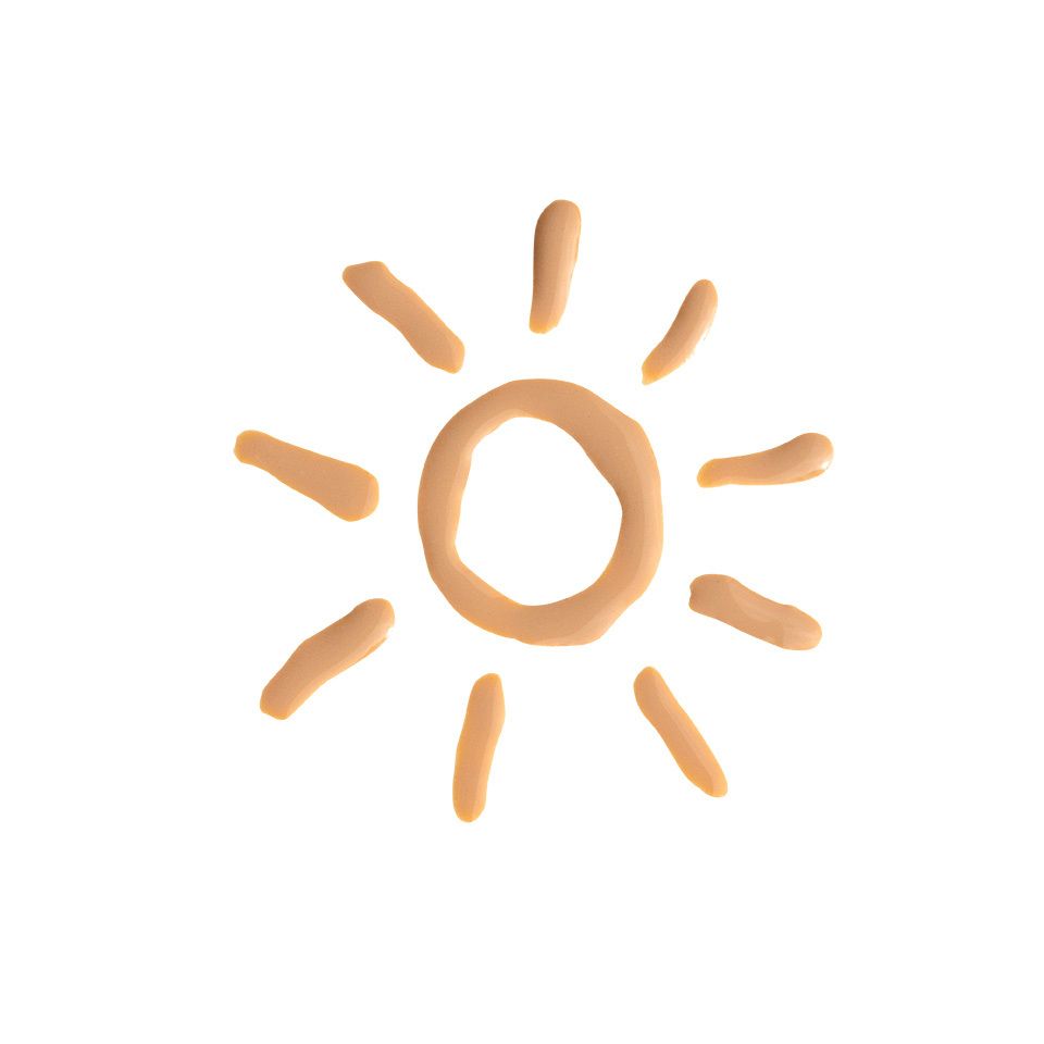 Dessin de soleil fait avec du produit. Nom et marque non visibles.
