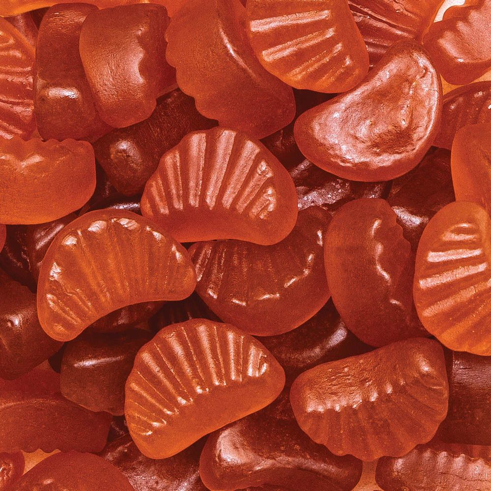 Gros plan sur des gommes segmentées orange. Forme de mandarine. Bactiol Gummies.