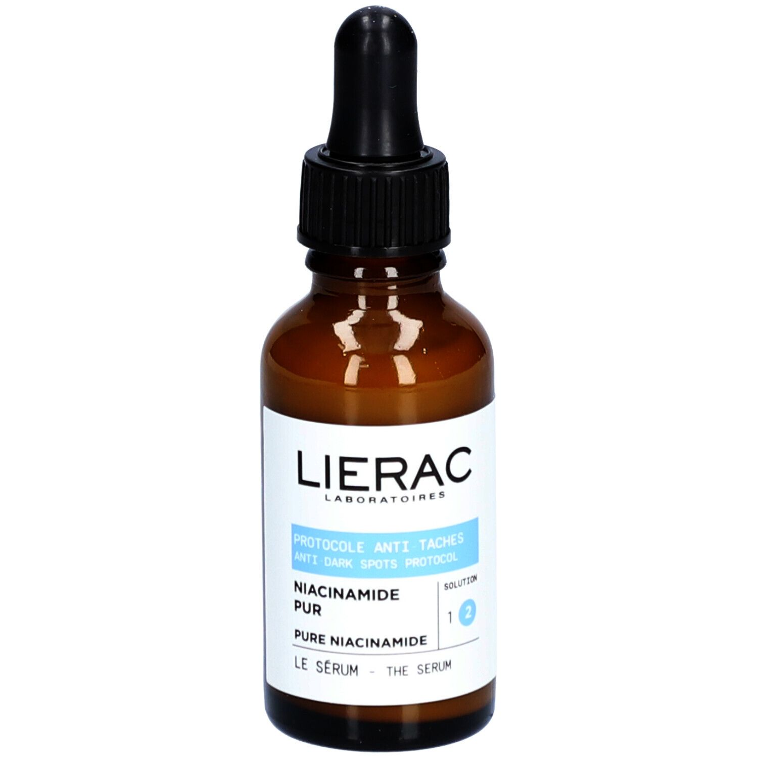 Flacon en verre brun avec pipette noire. Étiquette avec informations produit. Marque : Lierac.