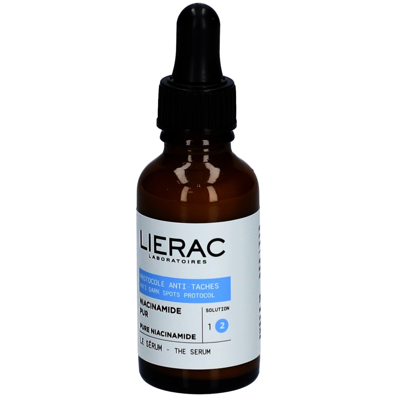 Flacon en verre brun avec pipette noire. Étiquette avec informations produit. Marque : Lierac.