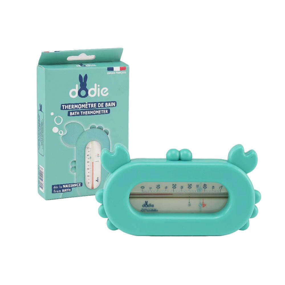 Thermomètre de bain Dodie Krabbe, turquoise. En forme de crabe avec affichage de la température. À côté de l'emballage.
