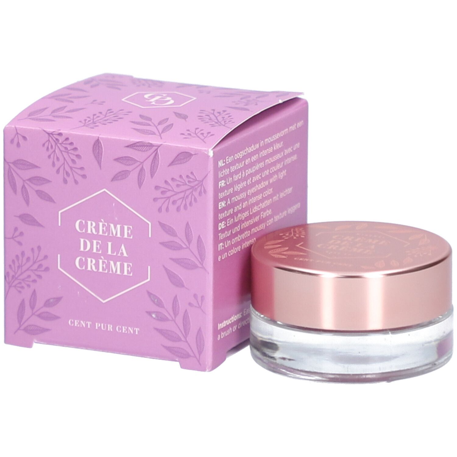 Crème lila dans un pot en verre avec un couvercle en or rose et une boîte assortie. "Crème de la Crème" est écrit sur la boîte.