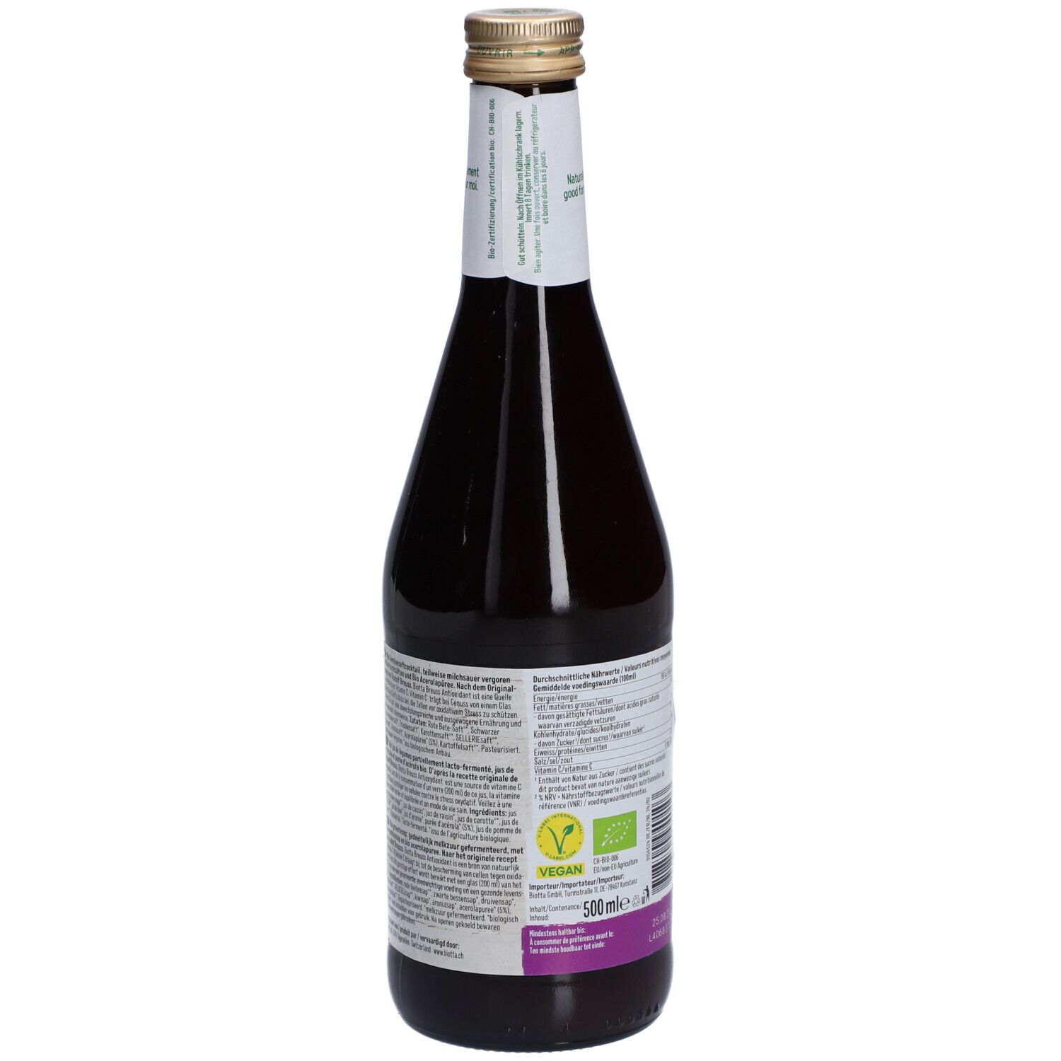 Dos d'une bouteille en verre de jus foncé. Étiquette avec informations nutritionnelles, liste des ingrédients, label vegan et code-barres.