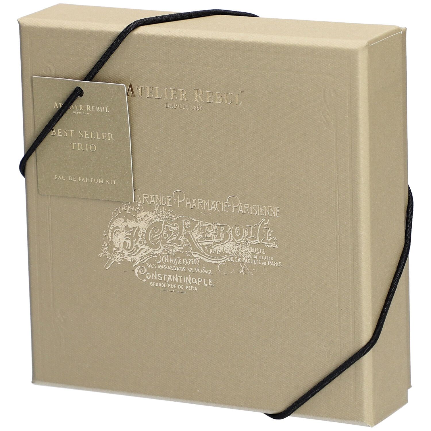 Coffret beige avec élastique noir. Étiquette : Atelier Rebul, Best Seller Trio, Eau de Parfum Kit.