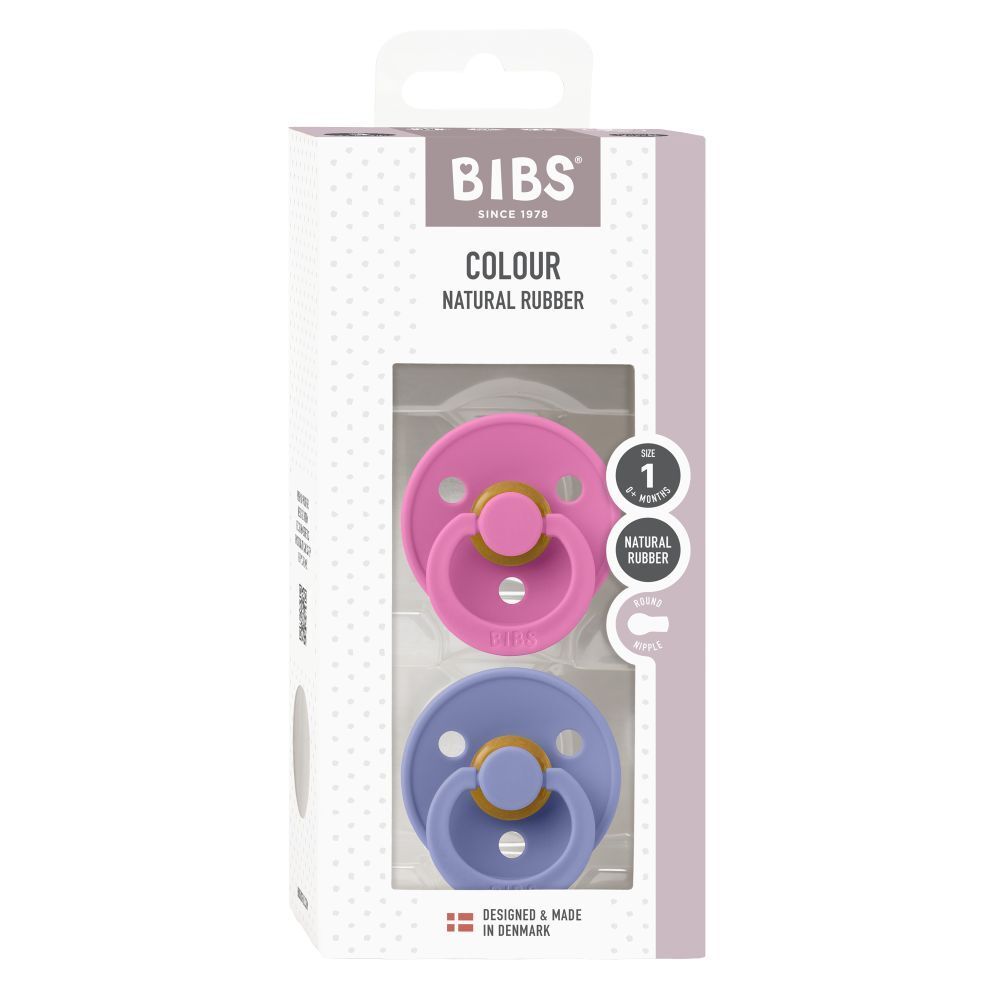 Emballage de deux sucettes. Sucettes roses et bleues. Marque BIBS, taille 1. Caoutchouc naturel. Fenêtre.
