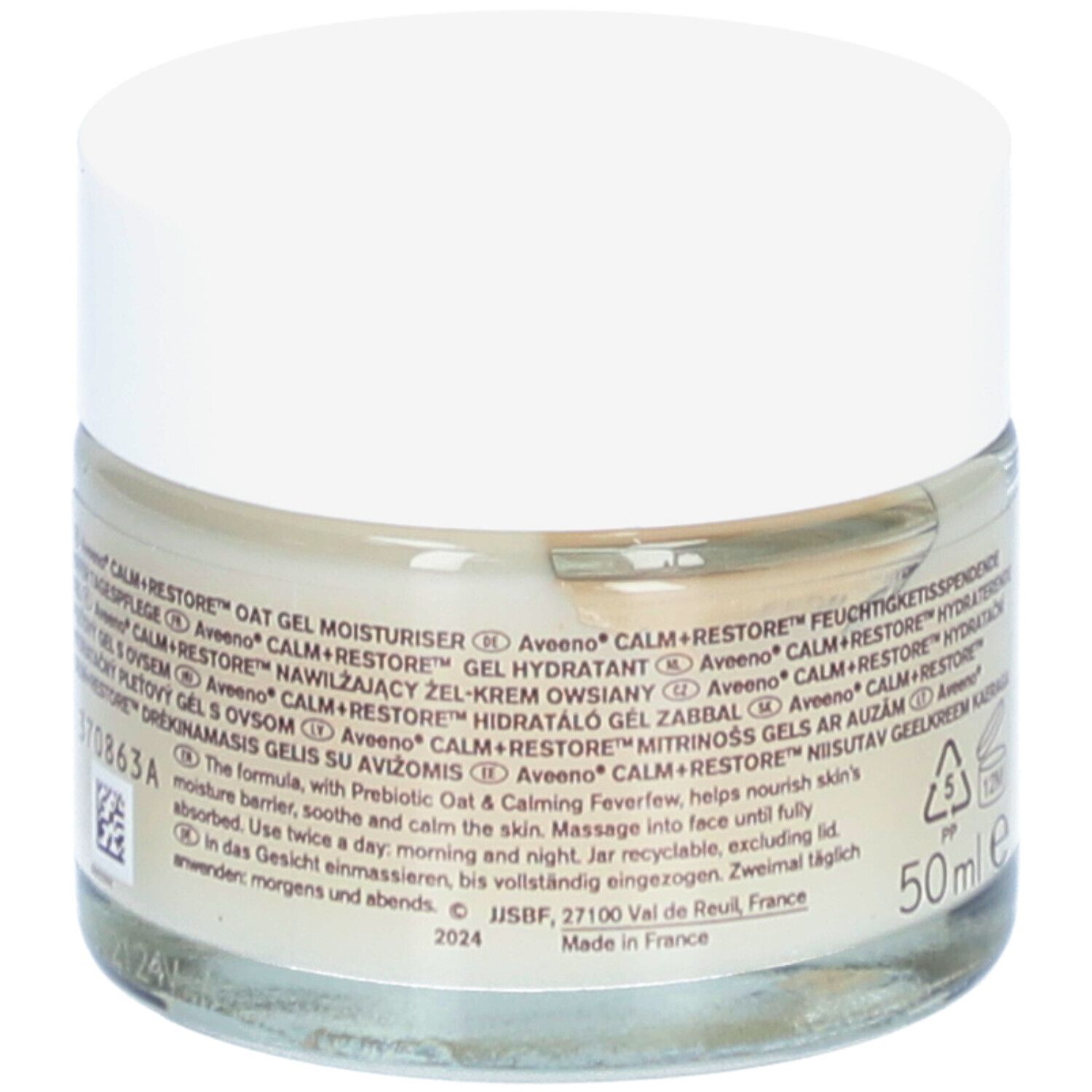 Pot de crème Aveeno CALM+RESTORE. Inscription, décor floral et 50ml. Couvercle blanc.