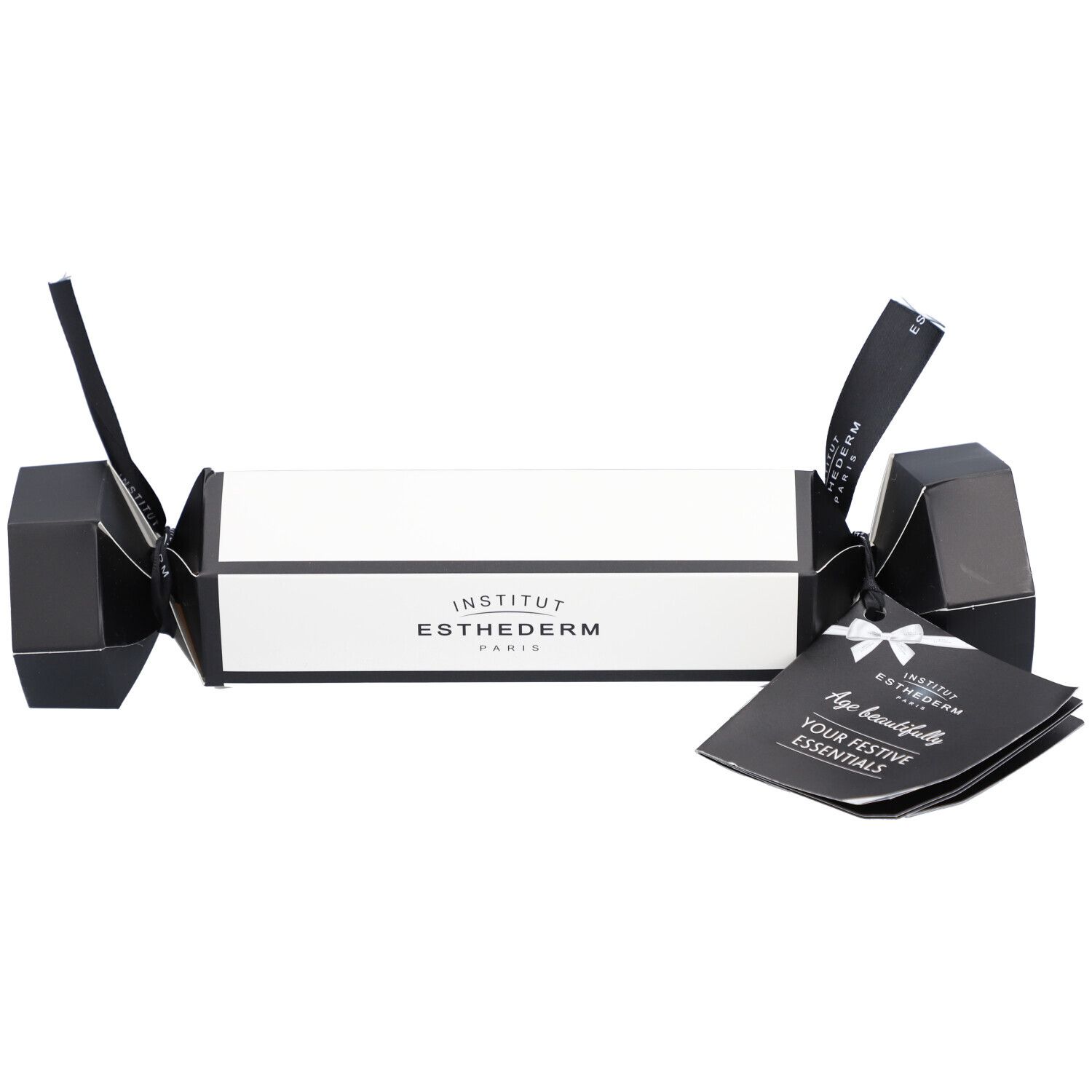Cracker cadeau Institut Esthederm. Emballage blanc et noir avec logo et texte. Comprend une brochure.