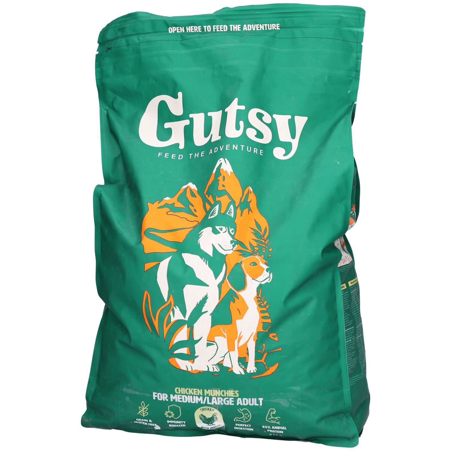 Grüne Tüte mit Gutsy-Logo und Abbildung von Hunden. Text: Chicken Munchies für mittelgroße/große Hunde. Reißverschluss oben.