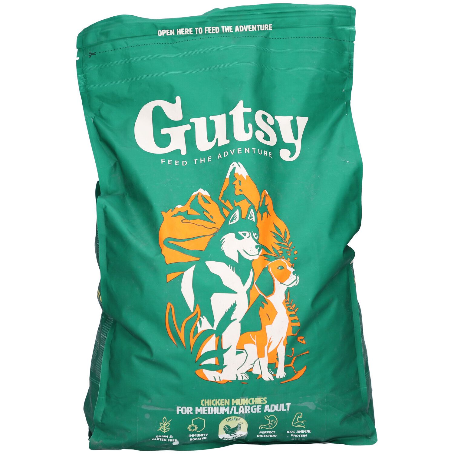 Grüne Tüte mit Gutsy-Logo und Abbildung von Hunden. Text: Chicken Munchies für mittelgroße/große Hunde. Reißverschluss oben.