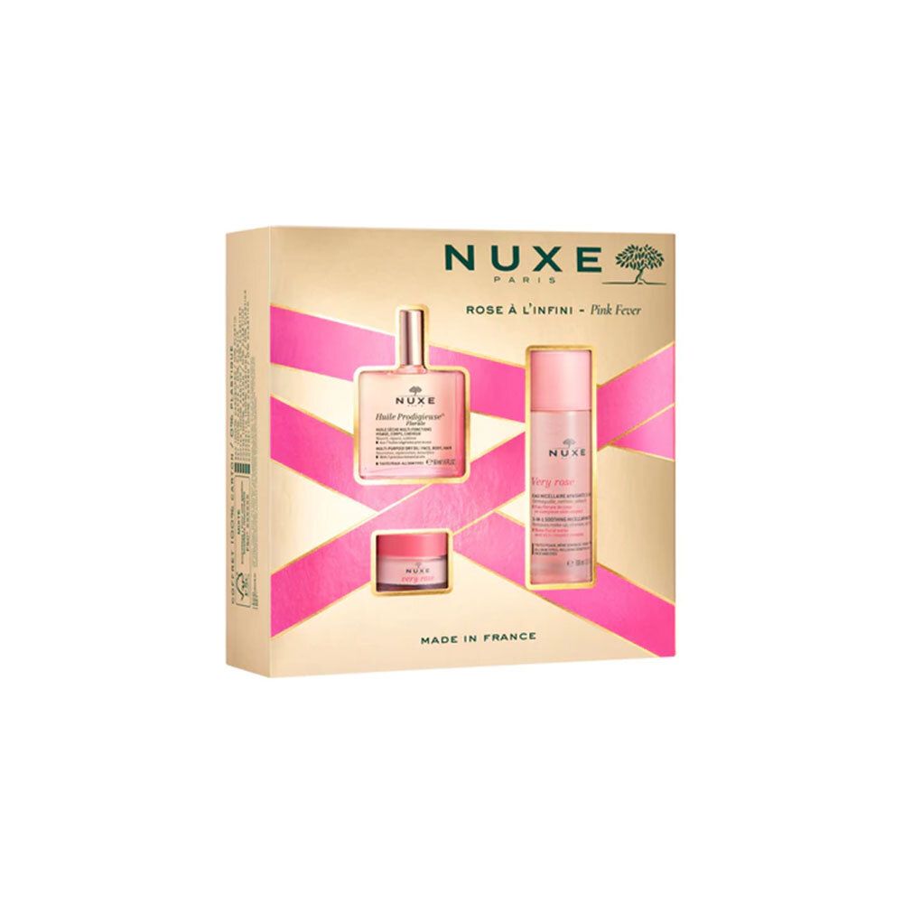 Coffret cadeau avec trois produits. Emballage doré avec accents roses. Logo Nuxe et noms de produits visibles.
