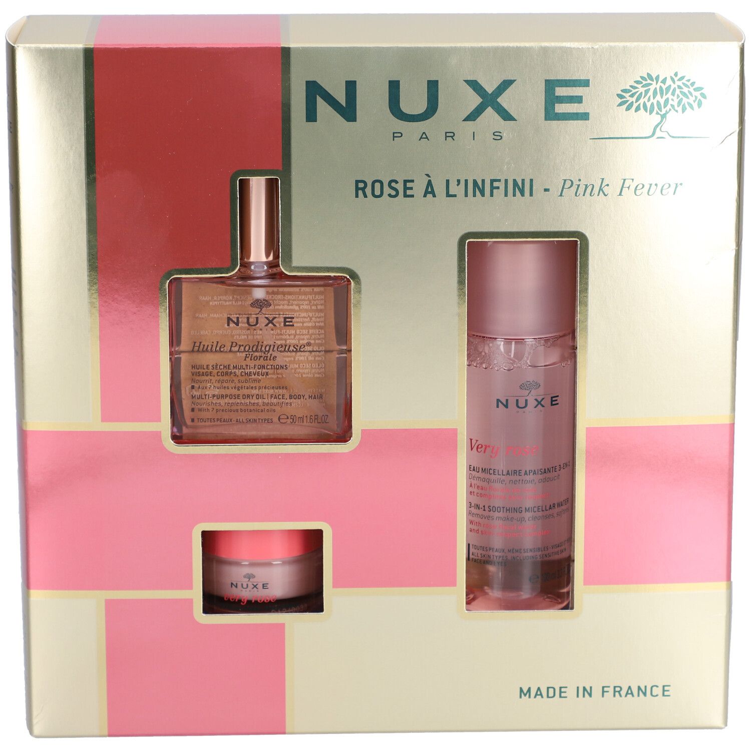 Coffret cadeau avec trois produits. Emballage doré avec accents roses. Logo Nuxe et noms de produits visibles.