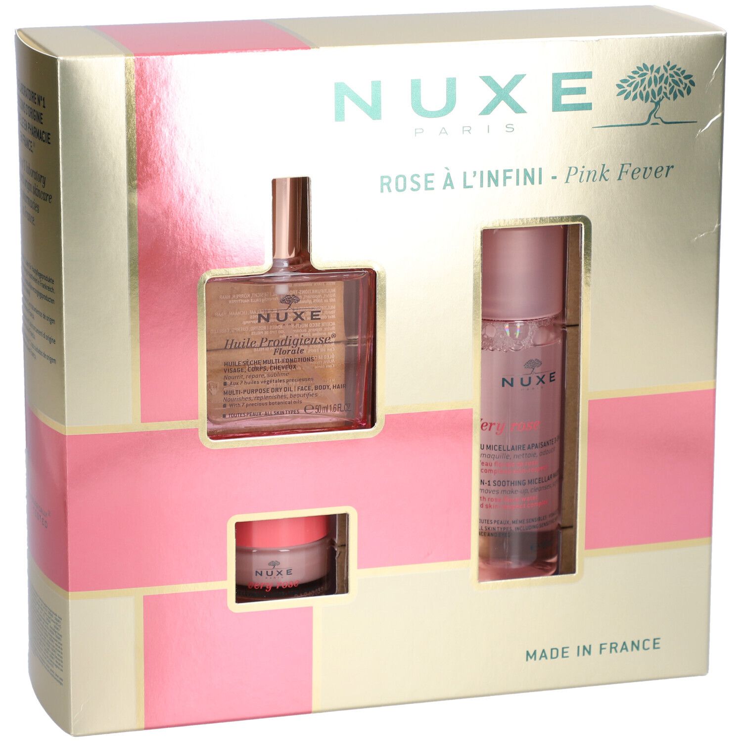 Coffret cadeau avec trois produits. Emballage doré avec accents roses. Logo Nuxe et noms de produits visibles.