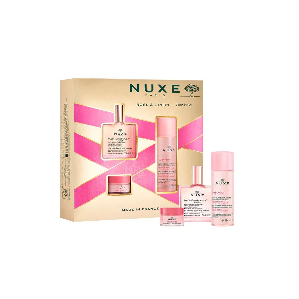 Coffret cadeau avec quatre produits. Emballage doré avec accents roses. Logo Nuxe et noms de produits visibles.