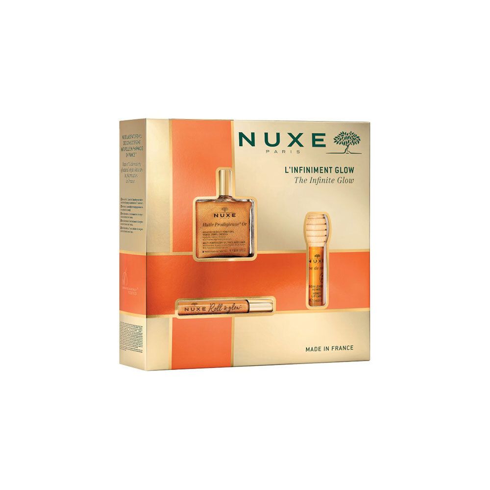 Coffret cadeau avec trois produits. Emballage doré-orangé avec images de produits et texte Nuxe L'Infiniment Glow.