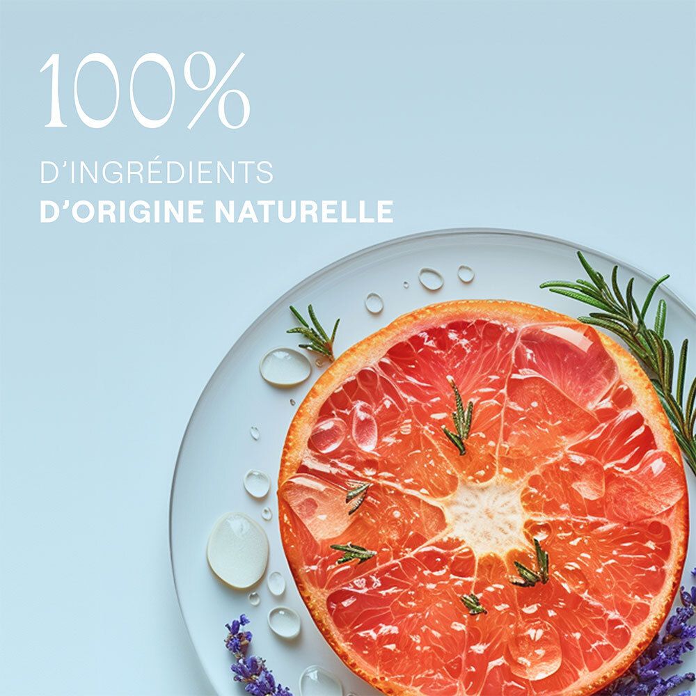 Moitié de pamplemousse sur une assiette avec romarin et lavande. Gouttes d'eau.