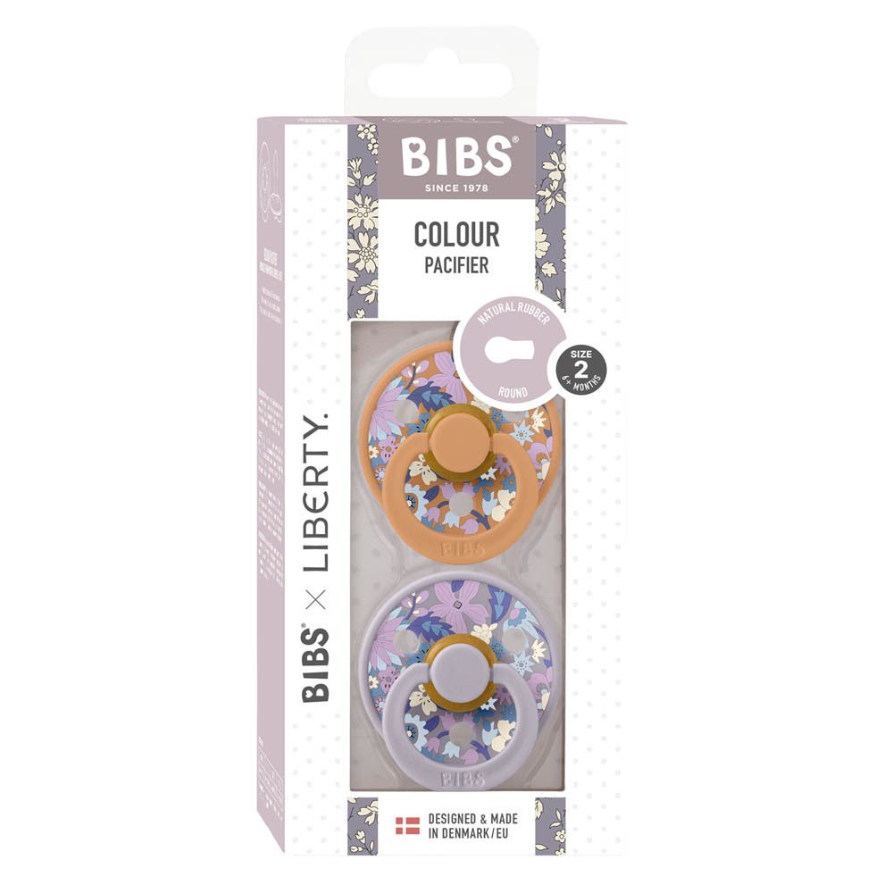 Deux sucettes BIBS® Liberty taille 2 dans un emballage. Motifs floraux. Logo BIBS® x Liberty sur l'emballage.