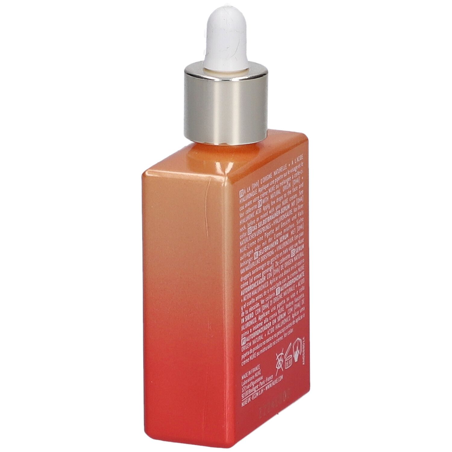 Sérum autobronzant Nuxe Prodigieuse Boost. Vue latérale du flacon avec texte. Dégradé orange et rouge.