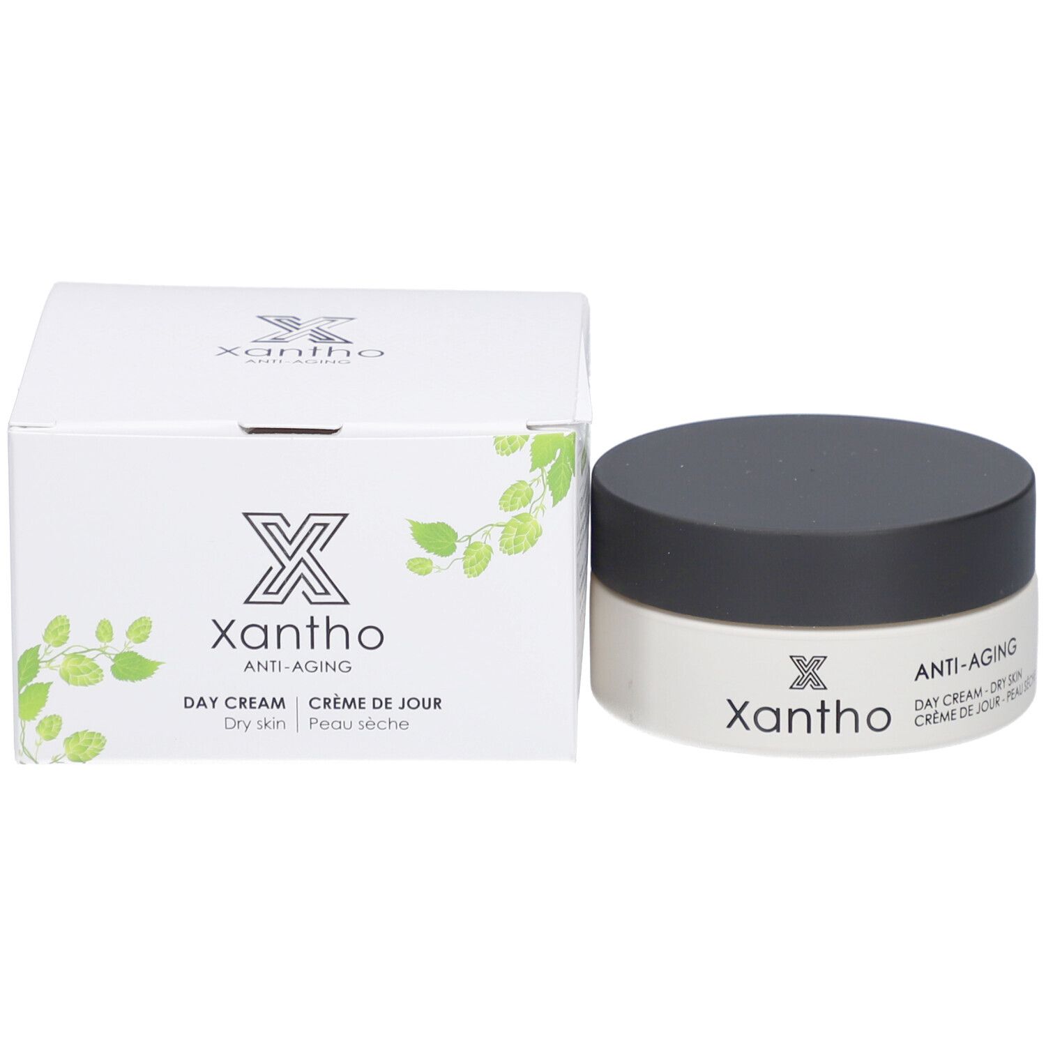 Cremebehälter und Karton. Aufschrift: Xantho, Anti-Aging, Day Cream, Dry skin, Crème de Jour, Peau sèche. Mit grünen Blättern.