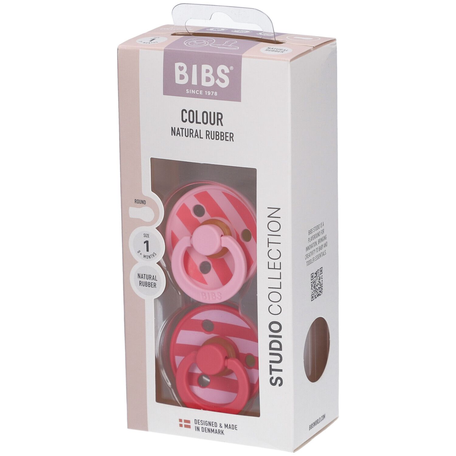 Verpackung mit zwei Schnullern. BIBS-Logo, Schriftzug 'Colour Natural Rubber'. Sichtfenster mit Schnullern in Rosa-Tönen.