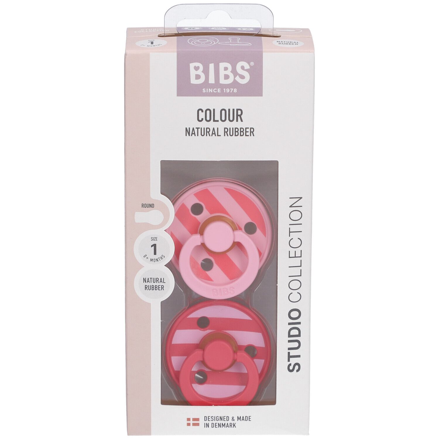 Verpackung mit zwei Schnullern. BIBS-Logo, 'Colour Natural Rubber'. Sichtfenster mit Schnullern in Rosa-Tönen.
