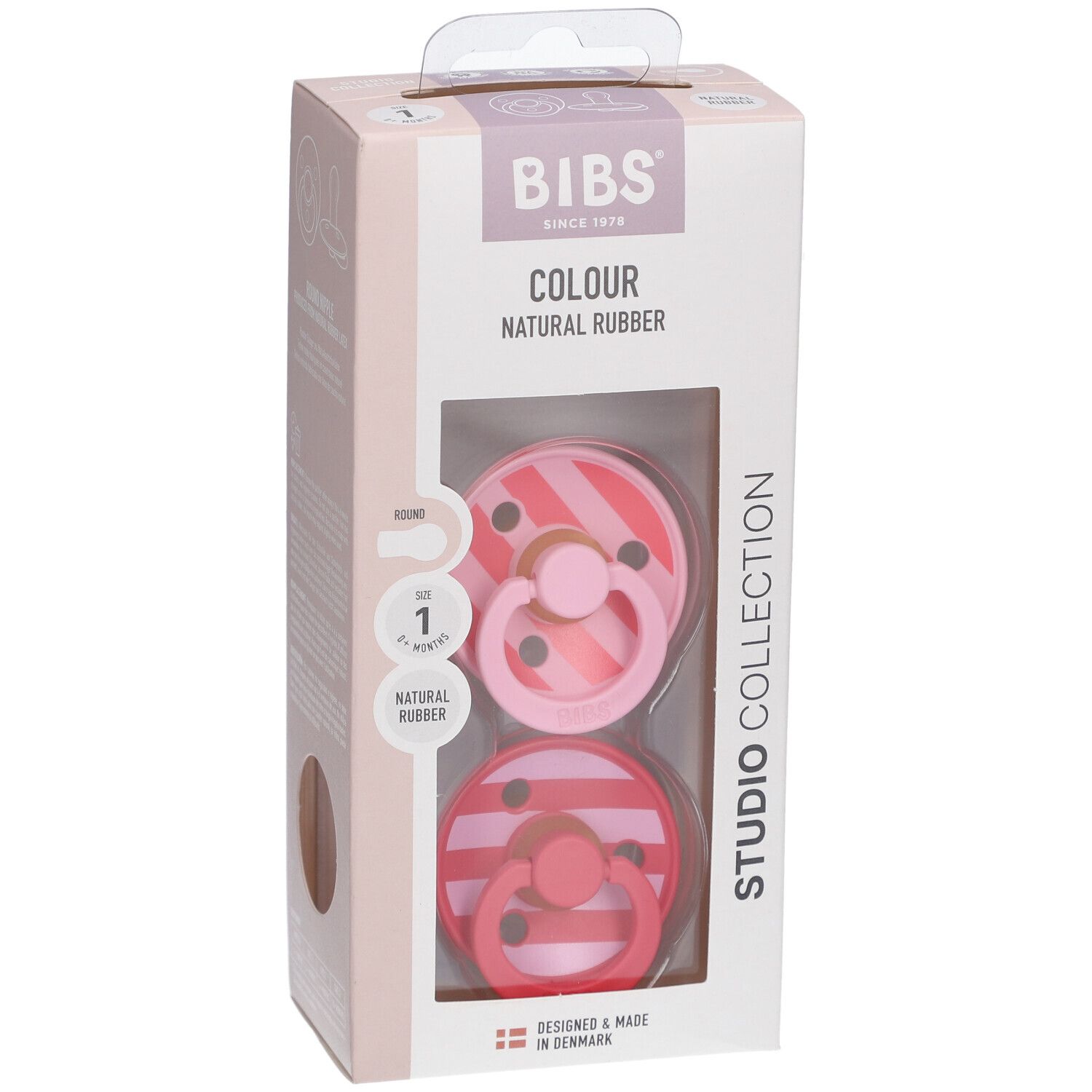 Verpackung mit zwei Schnullern. BIBS-Logo, 'Colour Natural Rubber'. Sichtfenster mit Schnullern in Rosa-Tönen.