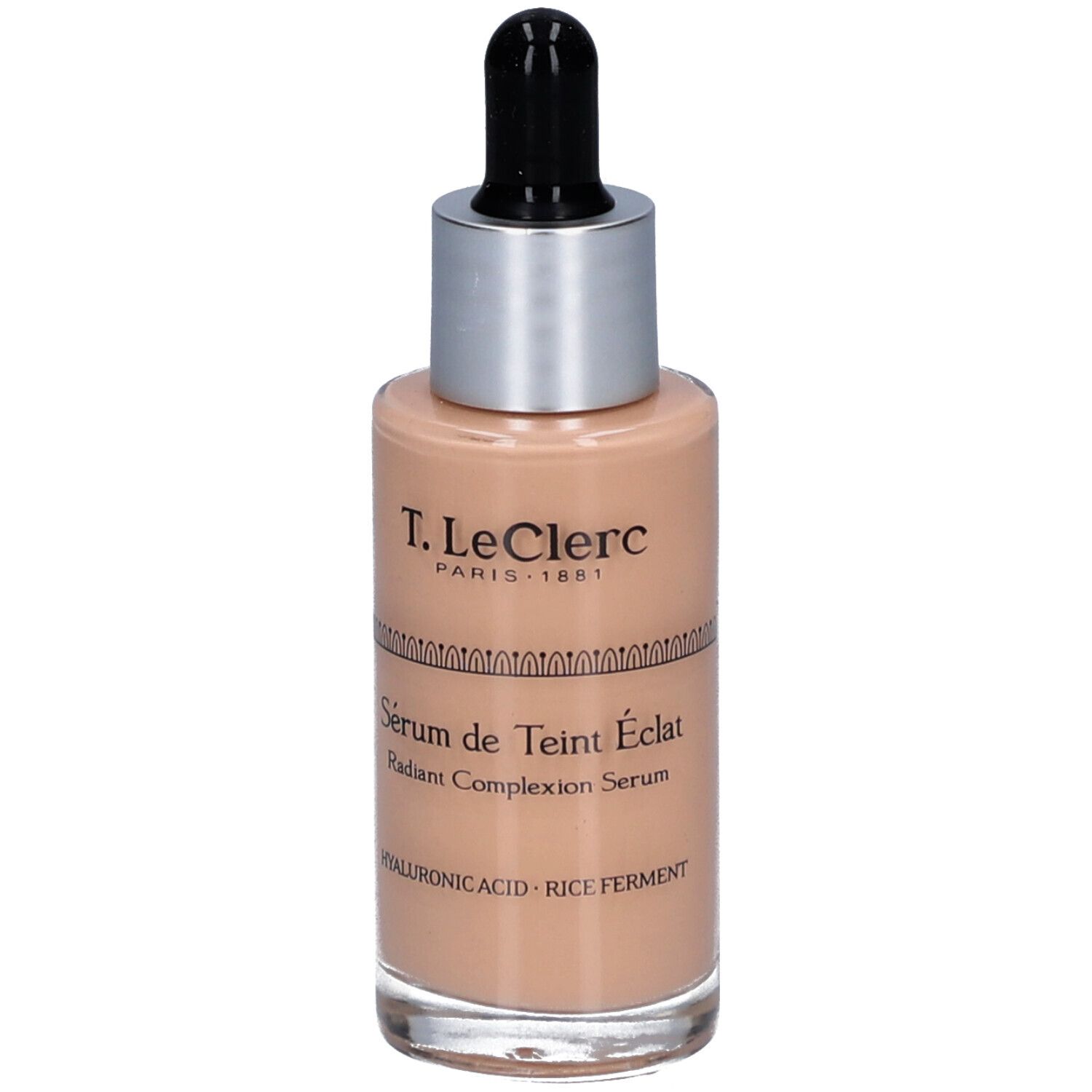T.LeClerc Serumflasche. Beige Flüssigkeit, silberner Deckel, schwarze Pipette. Beschriftung: Sérum de Teint Éclat, Radiant Complexion Serum.