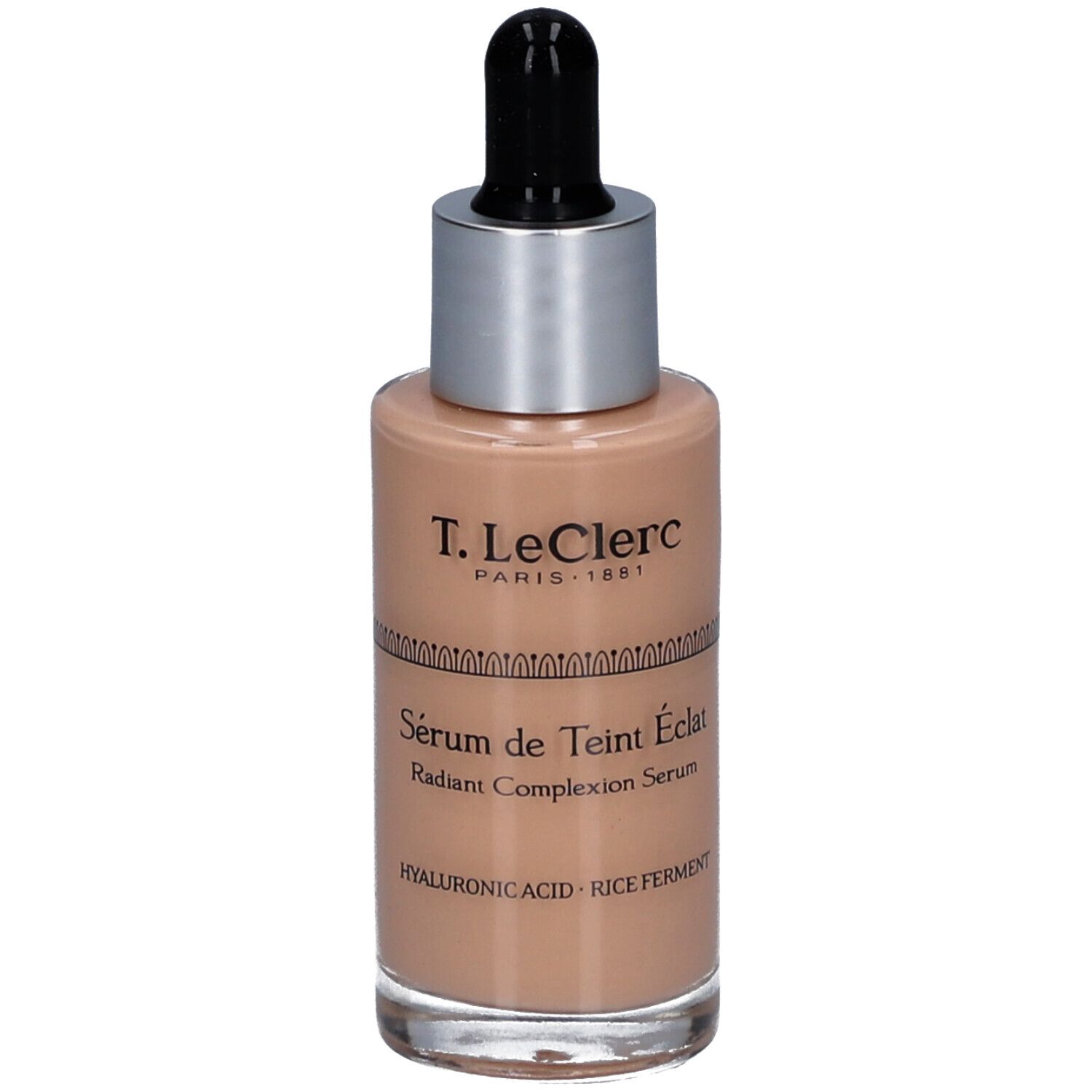 T.LeClerc Serumflasche. Beige Flüssigkeit, silberner Deckel, schwarze Pipette. Beschriftung: Sérum de Teint Éclat, Radiant Complexion Serum.