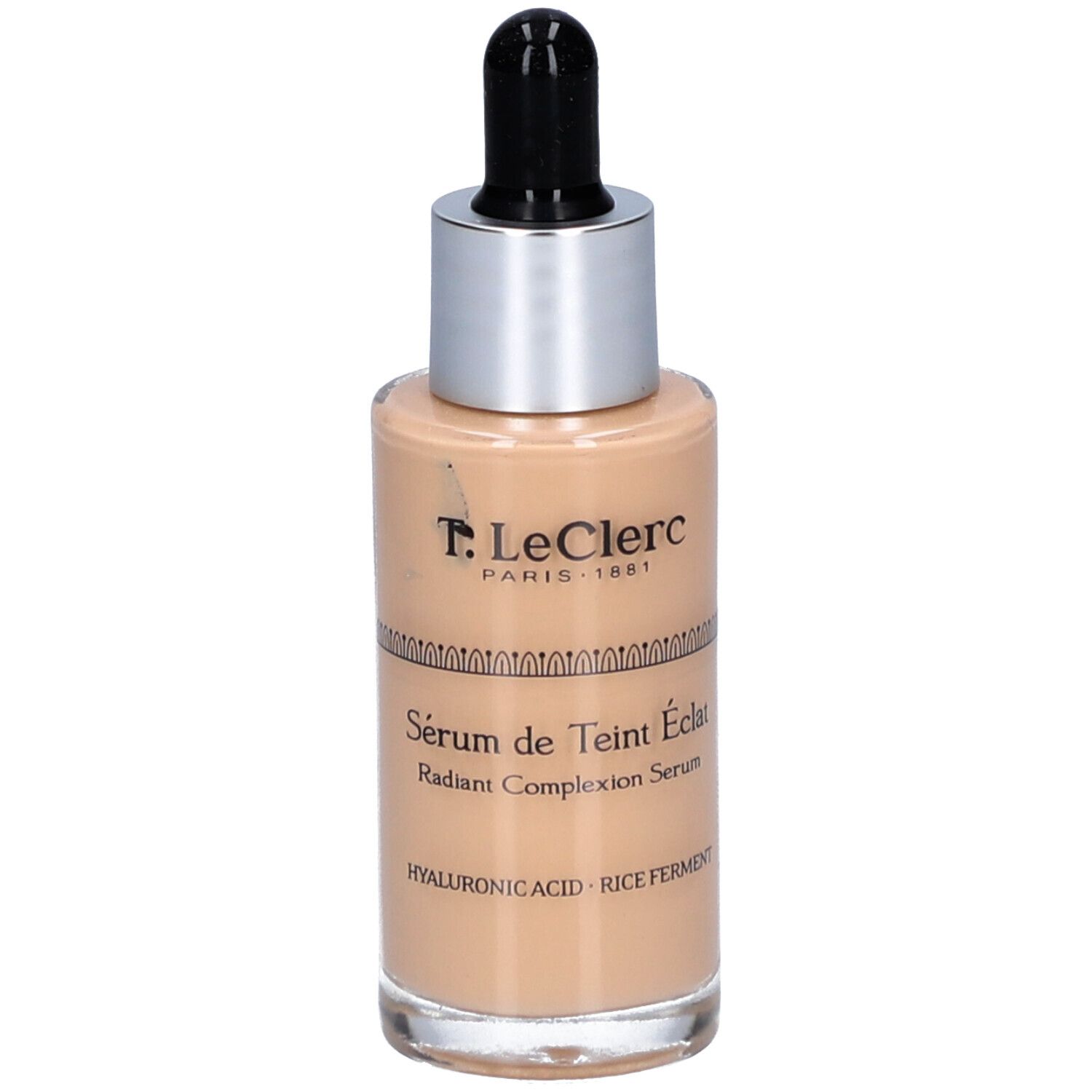 T.LeClerc Serumflasche. Beige Flüssigkeit, silberner Deckel, schwarze Pipette. Text: Sérum de Teint Éclat.