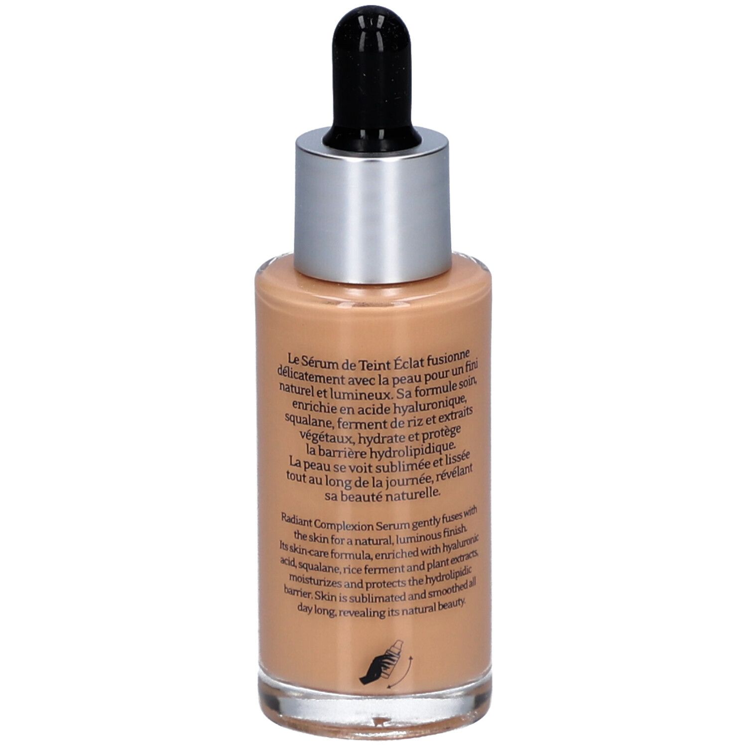 Rückansicht der Serumflasche. Text: Sérum de Teint Éclat, Radiant Complexion Serum. Beschreibt die Wirkung auf die Haut.
