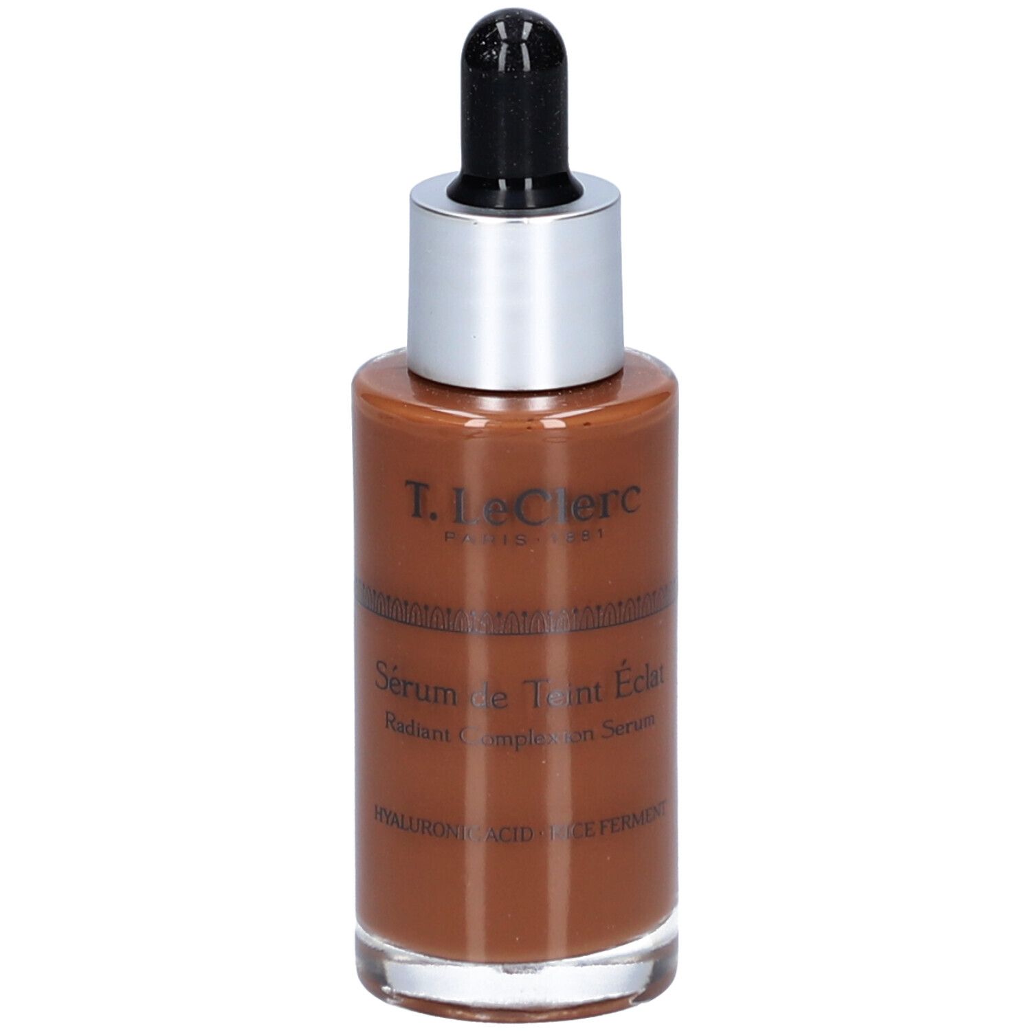 Braune Serumflasche mit silbernem Deckel und schwarzer Pipette. Beschriftung: T. LeClerc, Sérum de Teint Éclat, Radiant Complexion Serum.