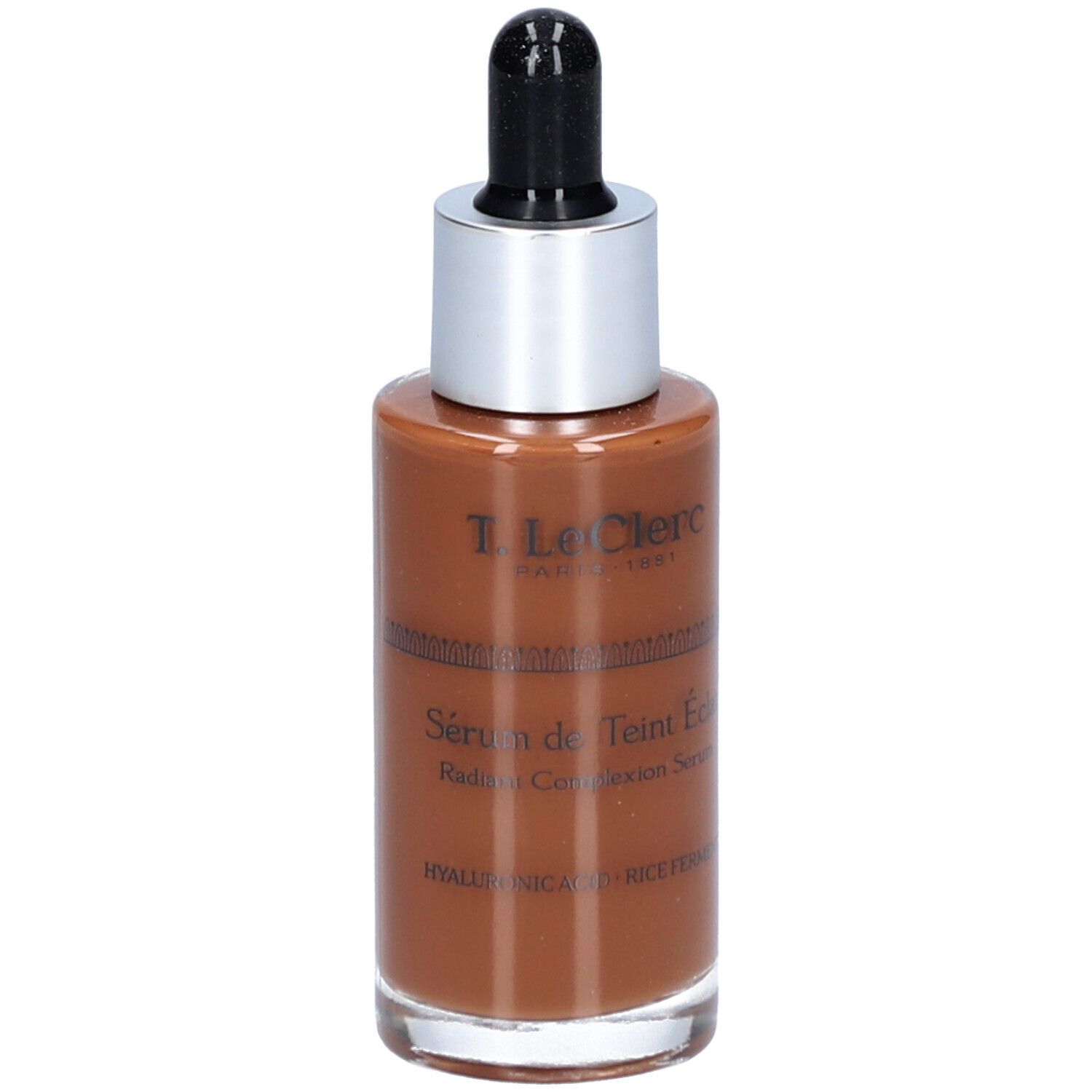 Braune Serumflasche mit silbernem Deckel und schwarzer Pipette. Beschriftung: T. LeClerc, Sérum de Teint Éclat, Radiant Complexion Serum.