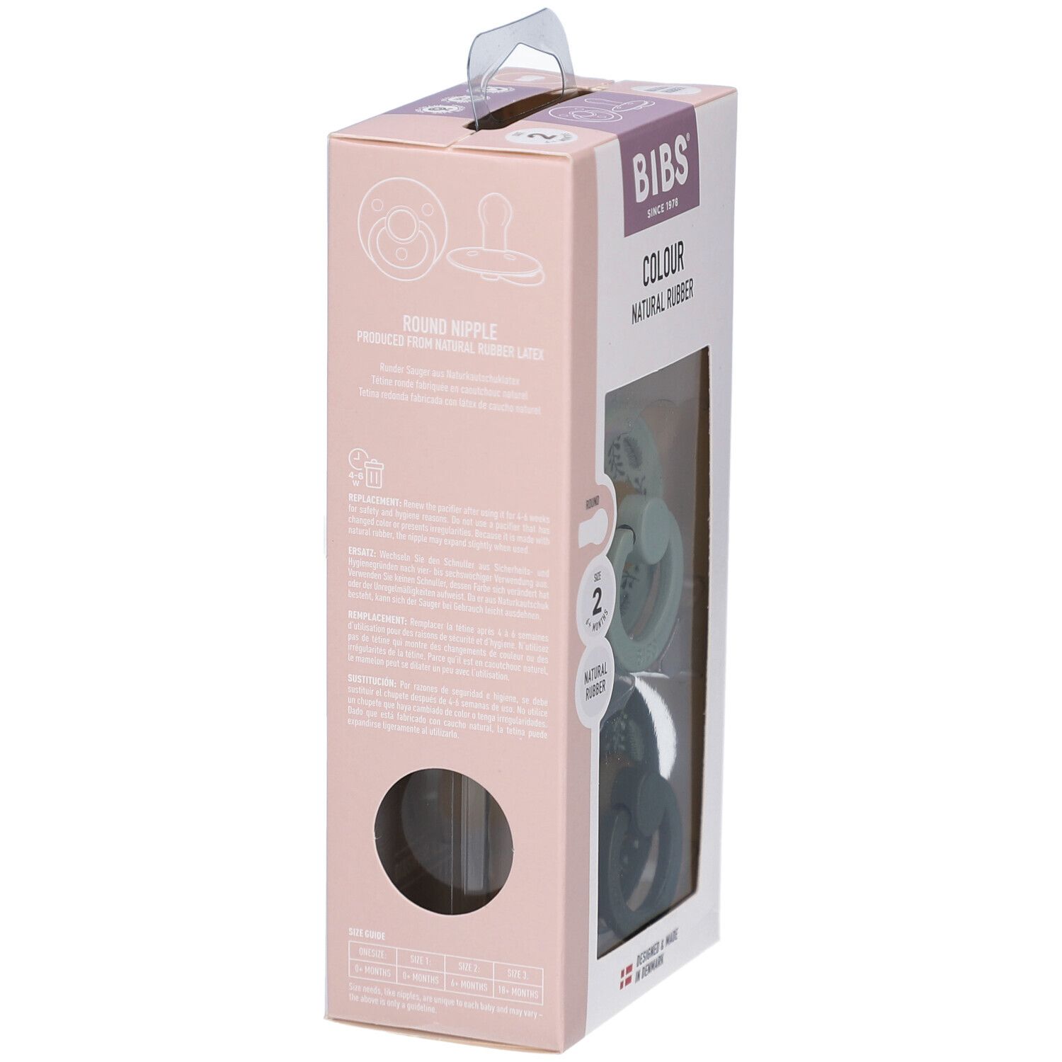 Verpackung mit zwei Schnullern. Marke BIBS, Schriftzug „COLOUR NATURAL RUBBER“. Größe 2, 6-18 Monate. Grün und dunkelgrün mit Blättermuster. Seitenansicht.
