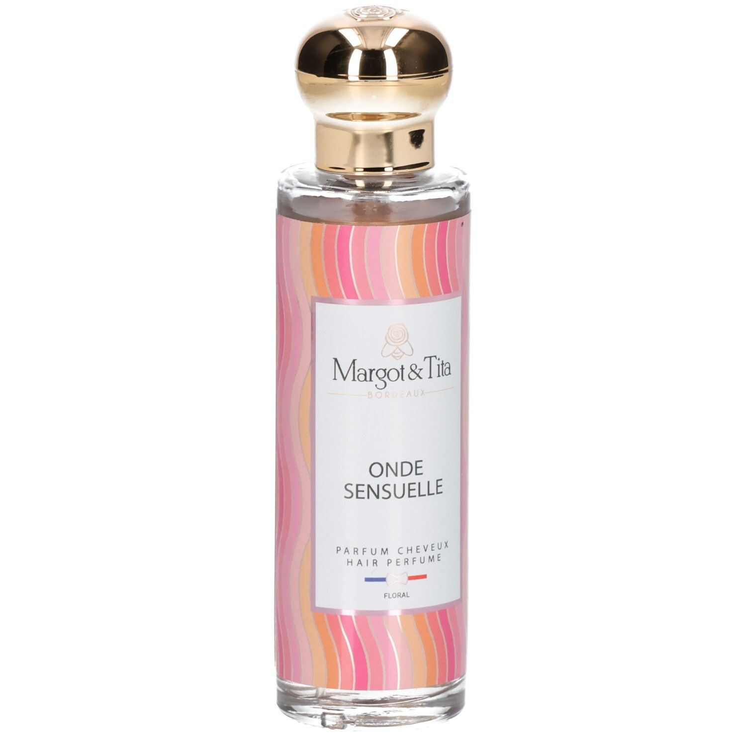 Flacon de parfum capillaire avec motif ondulé rose et orange, bouchon doré et étiquette blanche mentionnant le nom du produit.