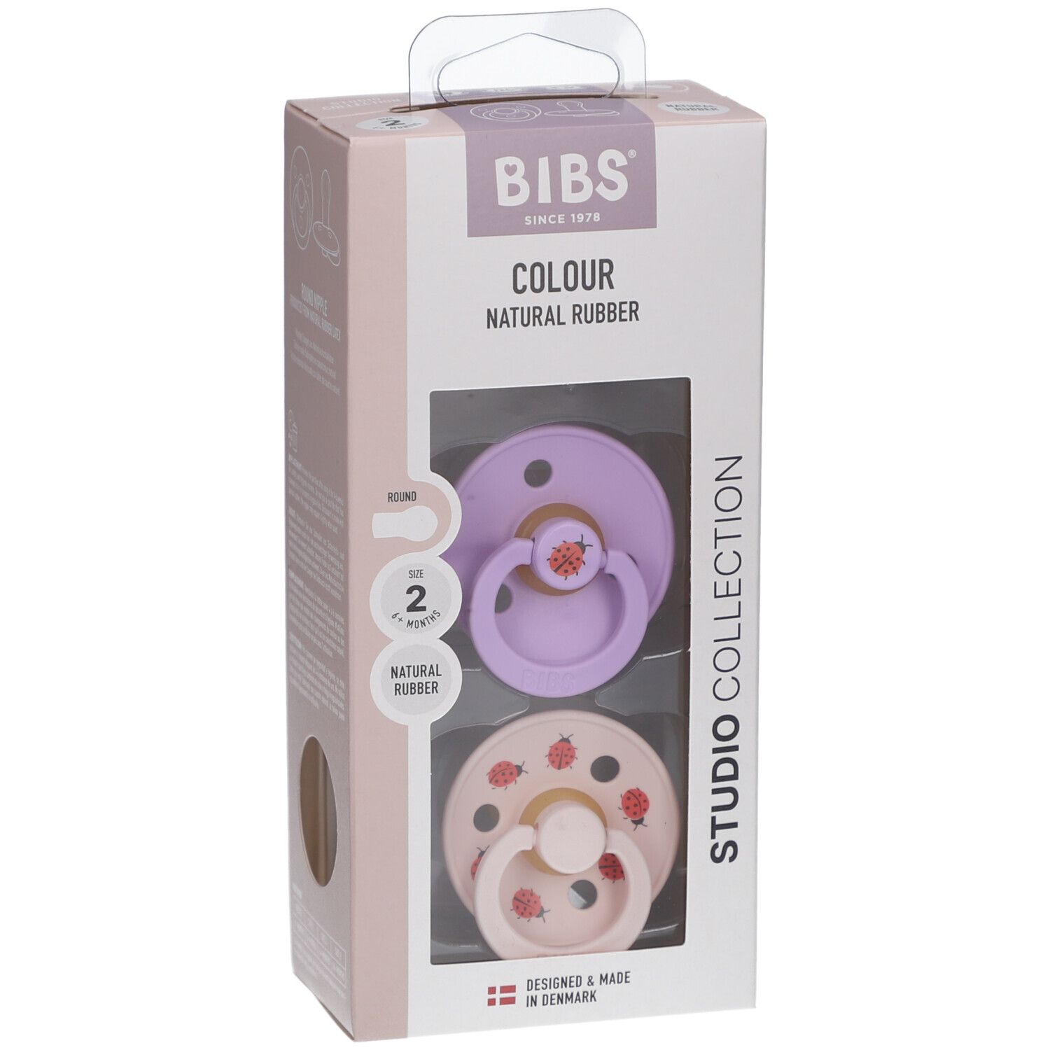 Verpackung mit zwei Schnullern. Lila und rosa Sauger mit Erdbeermotiven. Naturgummi. BIBS-Marke.